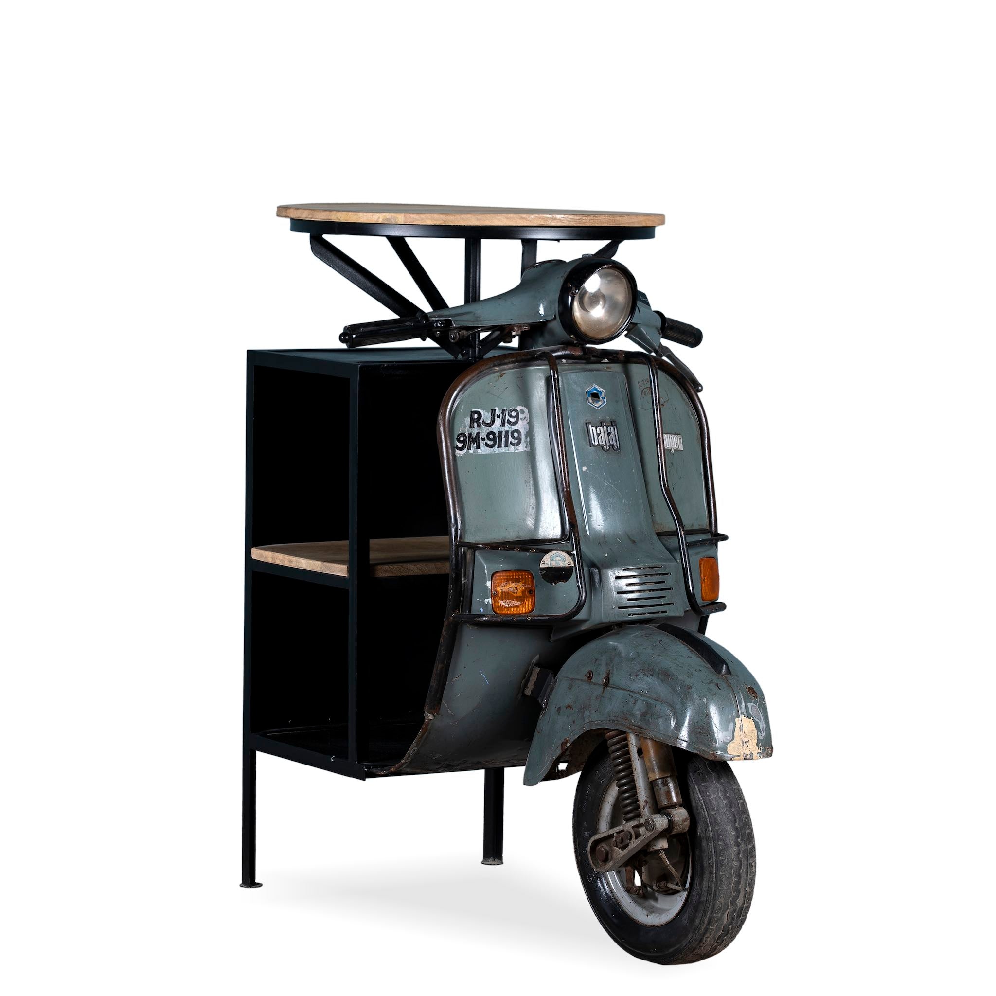 White background image of a short moto bar table crafted from the front half of an original Bajaj scooter, featuring a round wooden top, metal frame, and rustic industrial finish.