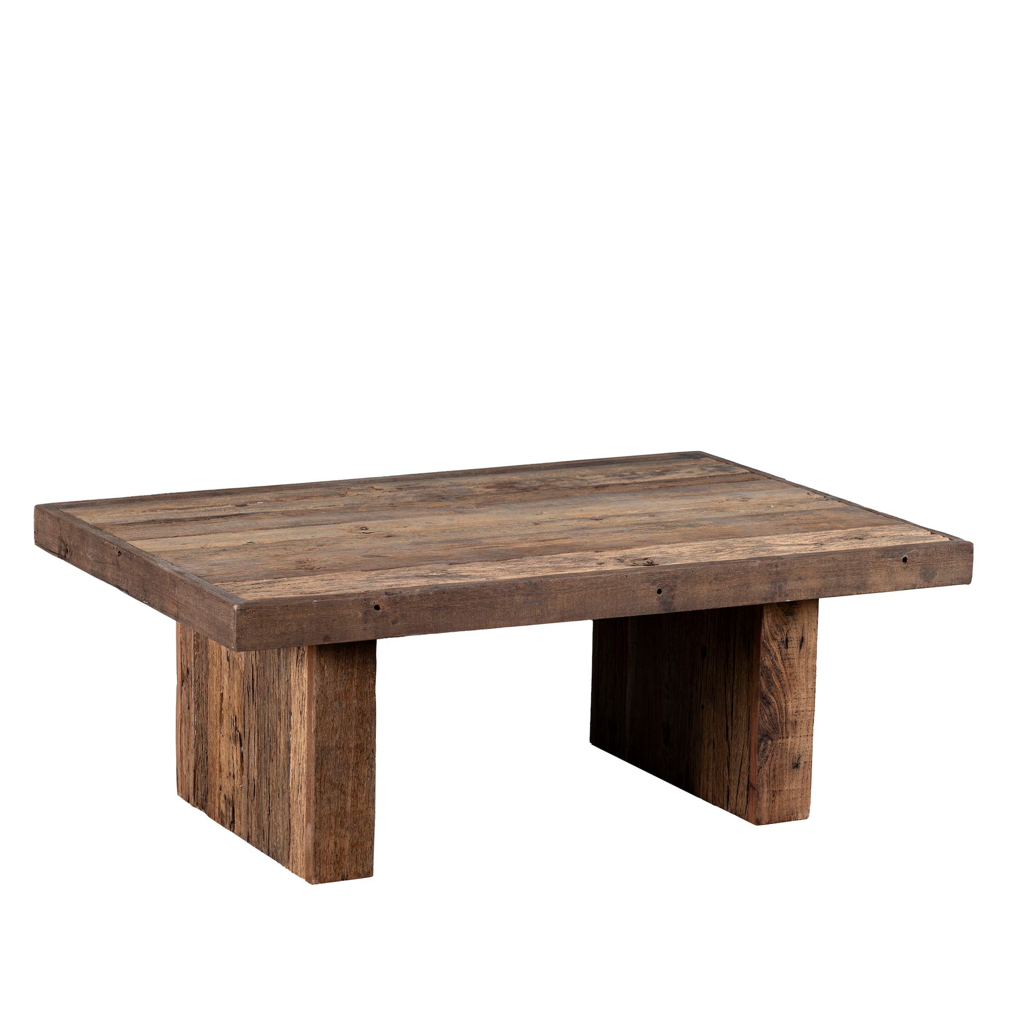 White background image of a rectangular rustic coffee table constructed from reclaimed wood, featuring a thick plank-style top and wide block legs, all with a naturally weathered finish that highlights the wood’s grain and imperfections.