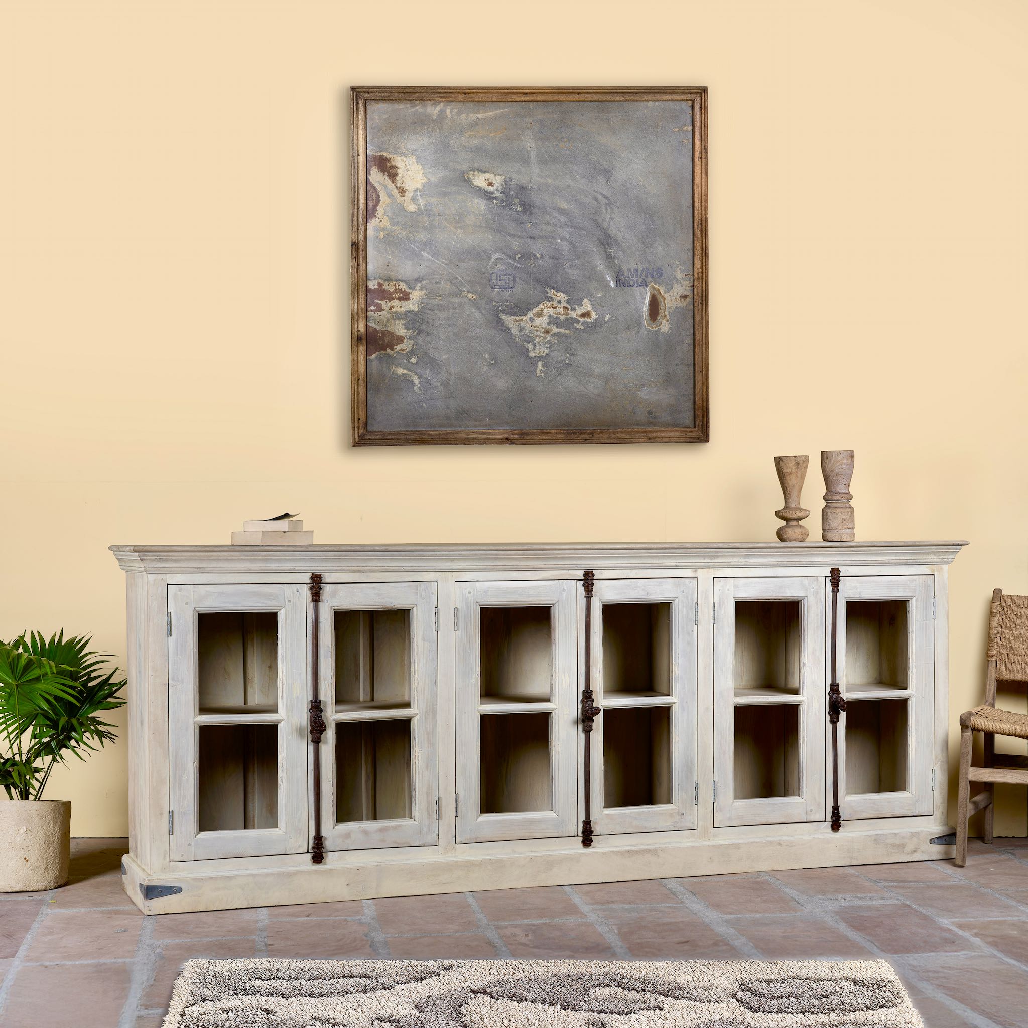 Side angle image of a sandblasted reclaimed wood sideboard in Ibiza style with four glass-panelled doors, vintage Mediterranean furniture, 263×45×100 cm.