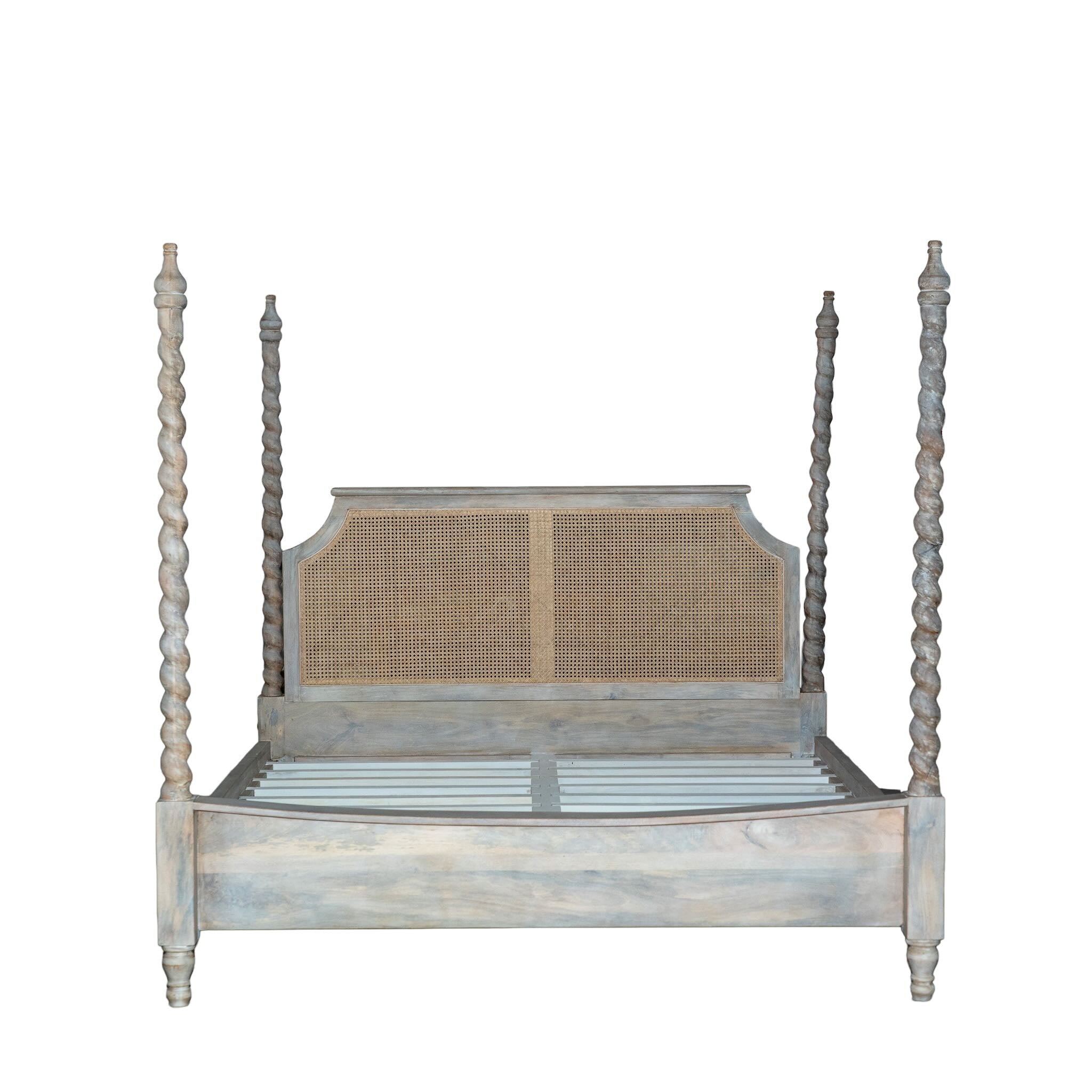 White background image of a King-size four-poster bed frame Aadinath made of solid mango wood with hand-carved twisted posts and cane-panel headboard, shown in a natural washed finish; part of a sustainable wooden canopy bed collection.