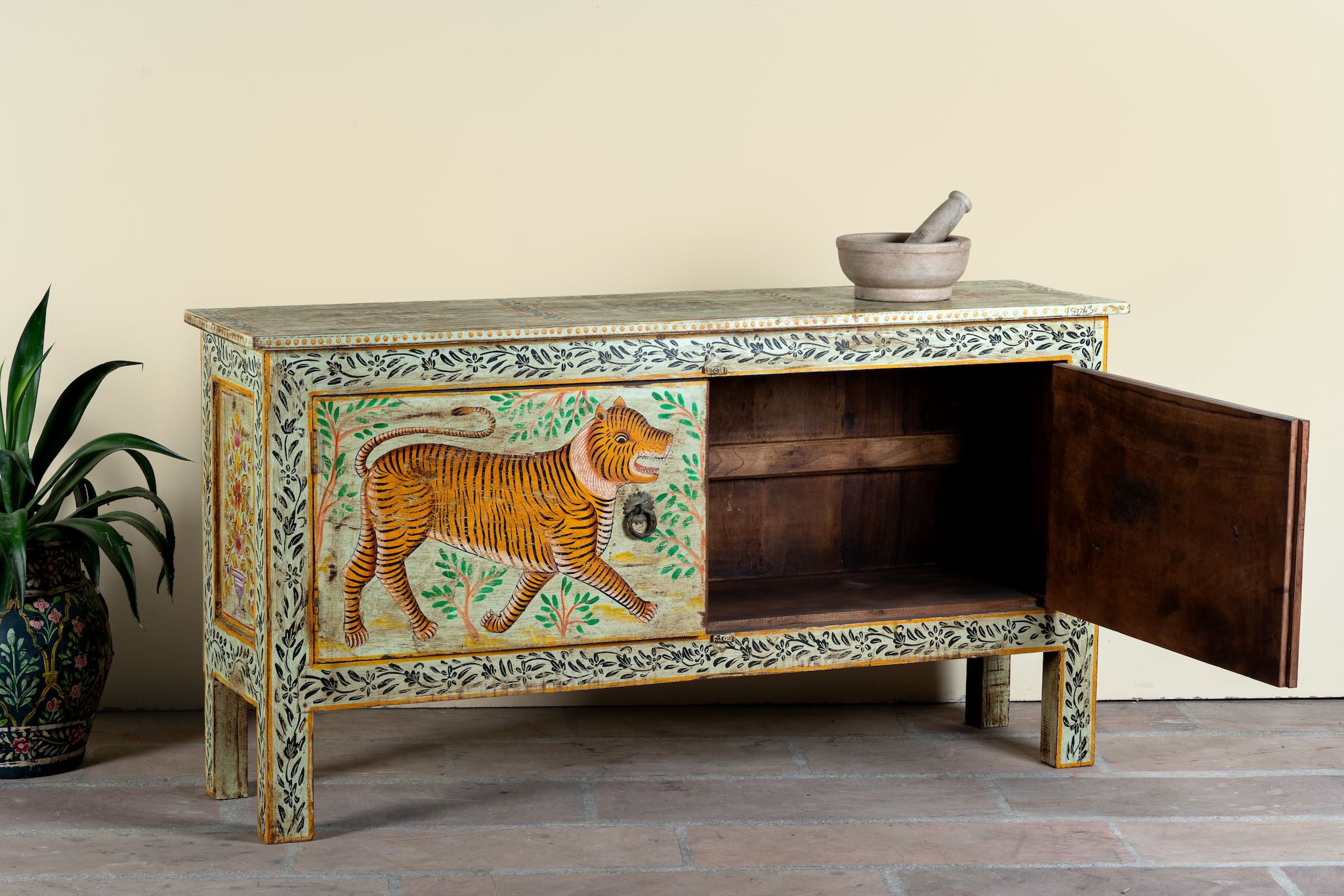 Side angle image with open door of a reclaimed wood console table Alina in a Boho Tiger design, featuring hand-painted tigers and floral details. A bold piece of artisanal furniture perfect for colourful and eclectic bohemian interiors.