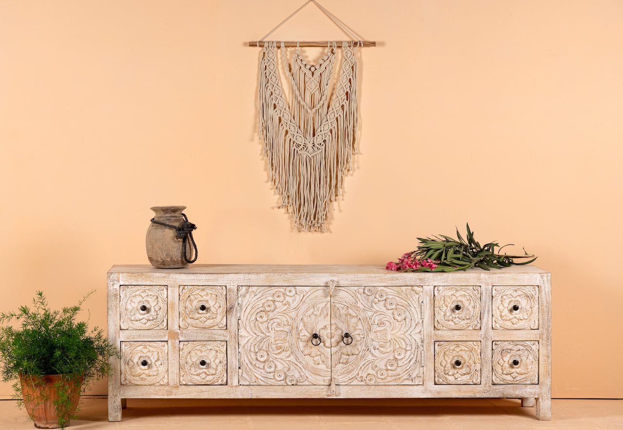 Whitewashed mango wood low board with hand-carved floral details, eight drawers and two compartments; ideal as a wooden low board or carved wood console table, 180 × 60 × 40 cm.