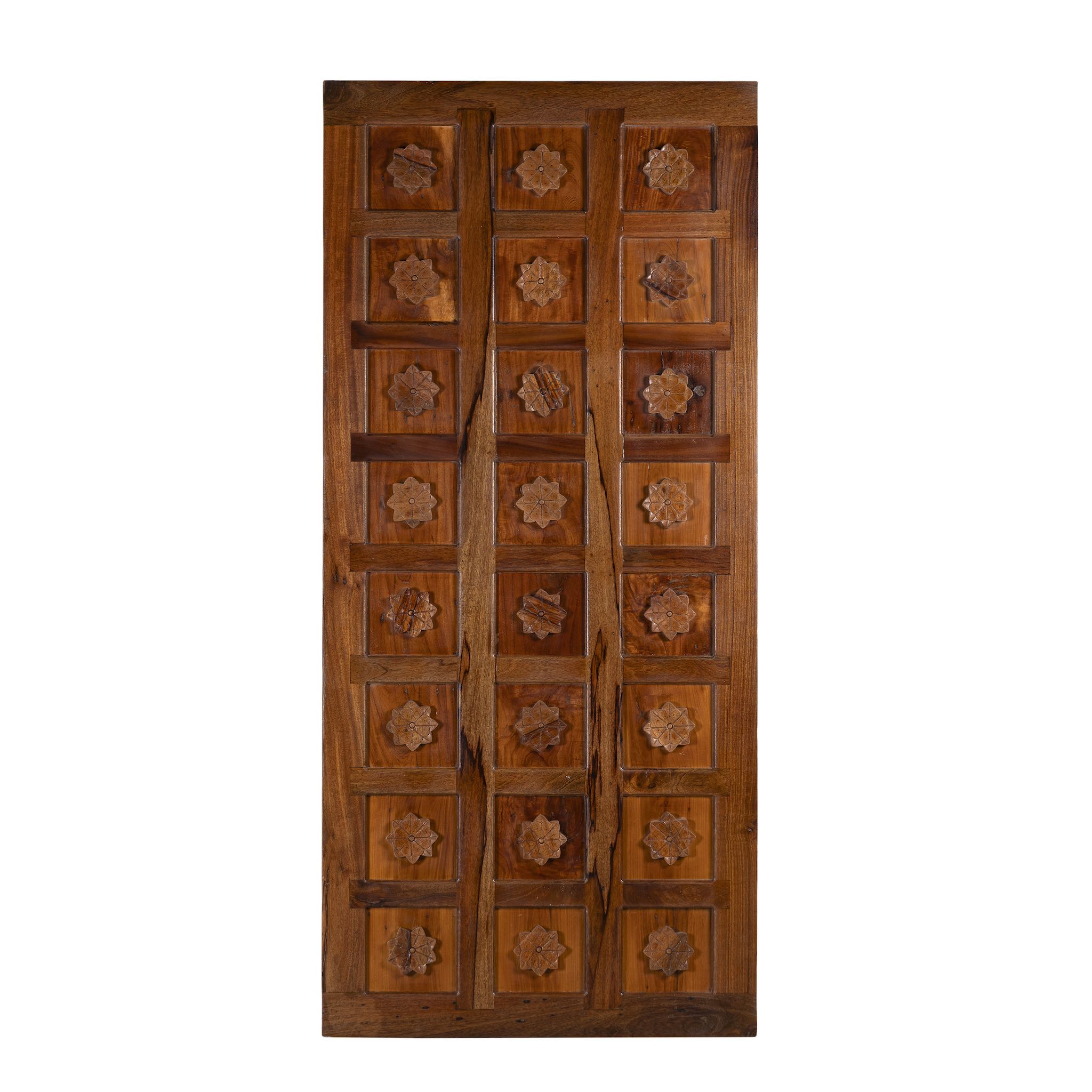 Wooden door with intricate carvings on a white background