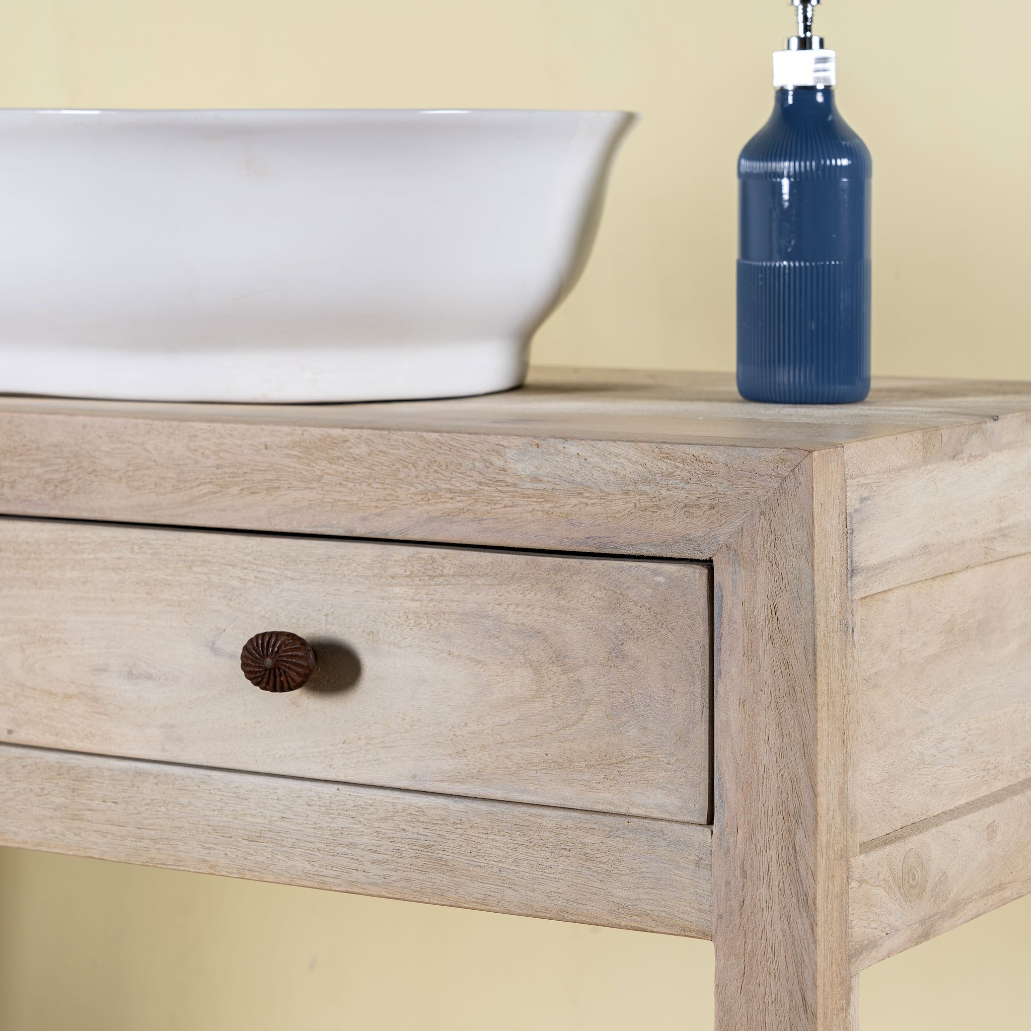 Close up image of a Ibiza style reclaimed wood console table with two drawers and a lower shelf, whitewashed finish, 100 × 40 × 90 cm.