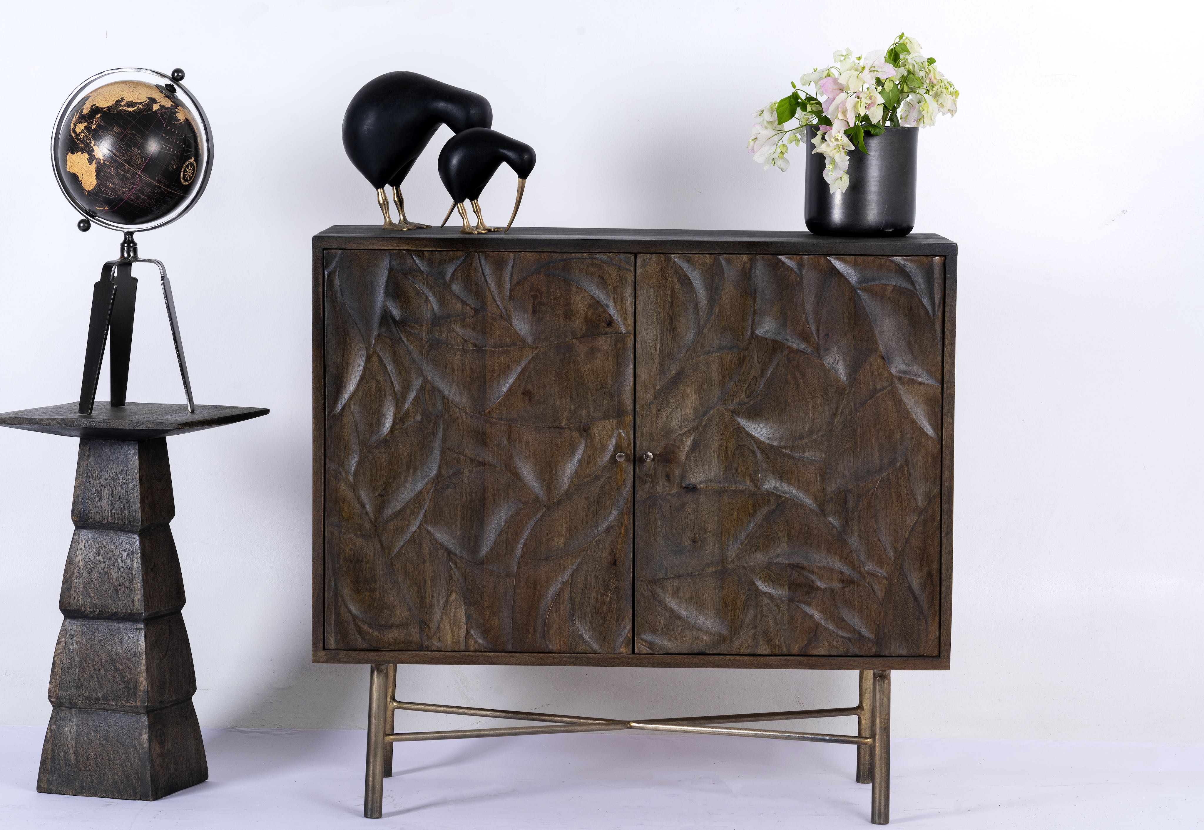 Hand-carved mango wood sideboard with brass-plated iron stand—an artisanal, minimalistic furniture piece combining natural warmth and modern elegance.