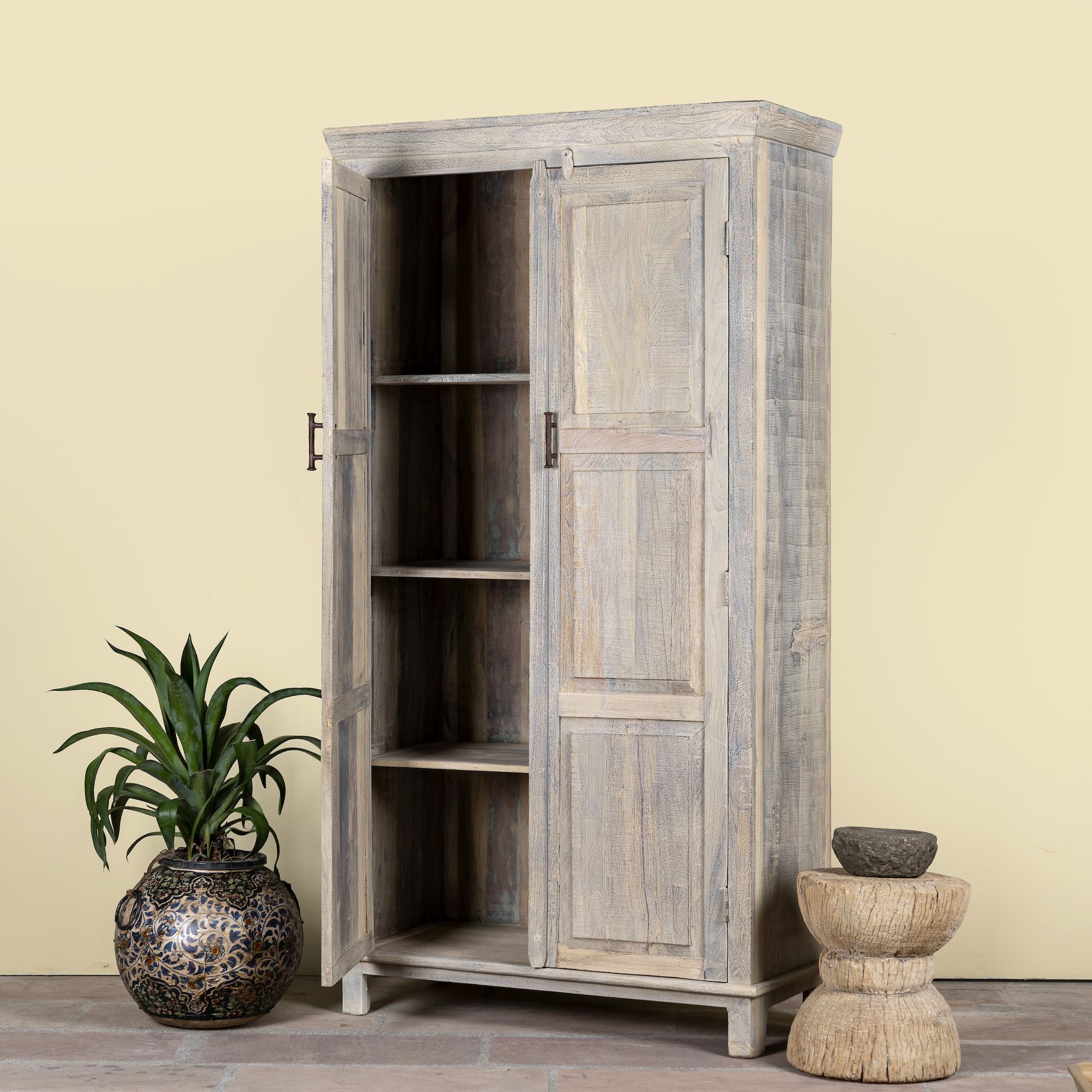 Side angle image with open doors of a reclaimed wood wardrobe with panelled double doors and rustic finish; bathroom furniture with ample storage, 100 × 45 × 190 cm.