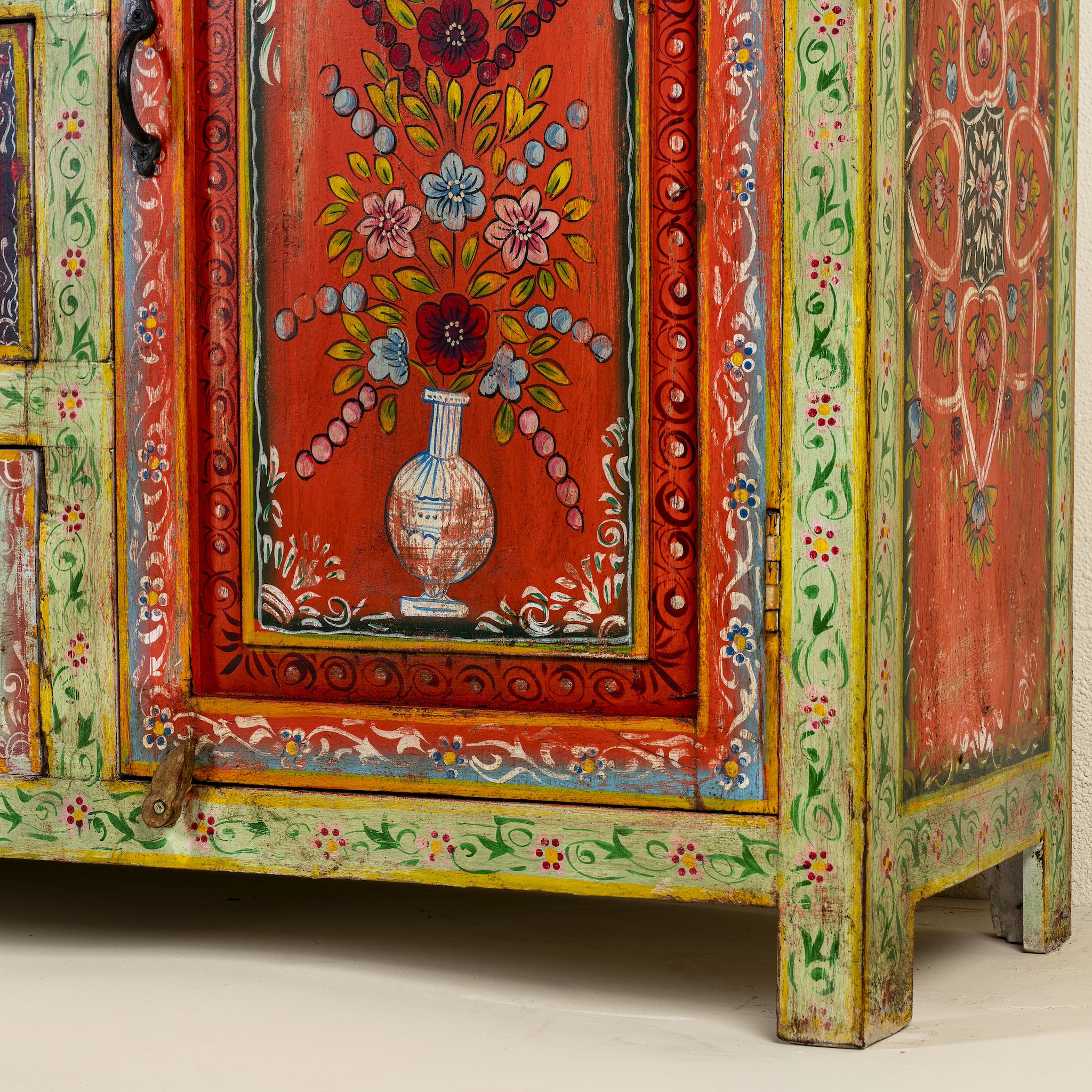 Close up image of a sustainable hand painted sideboard made from reclaimed teak wood with floral motifs; bold bohemian furniture, 150 × 45 × 90 cm.
