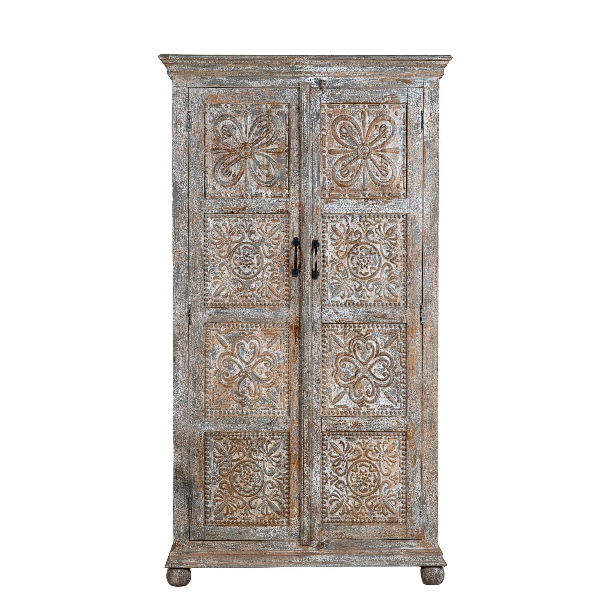 White background image of a hand-carved mango wood cabinet Ava in a vintage distressed finish with floral motifs. A stylish piece of mango wood furniture and vintage home accessory with practical storage and timeless charm.