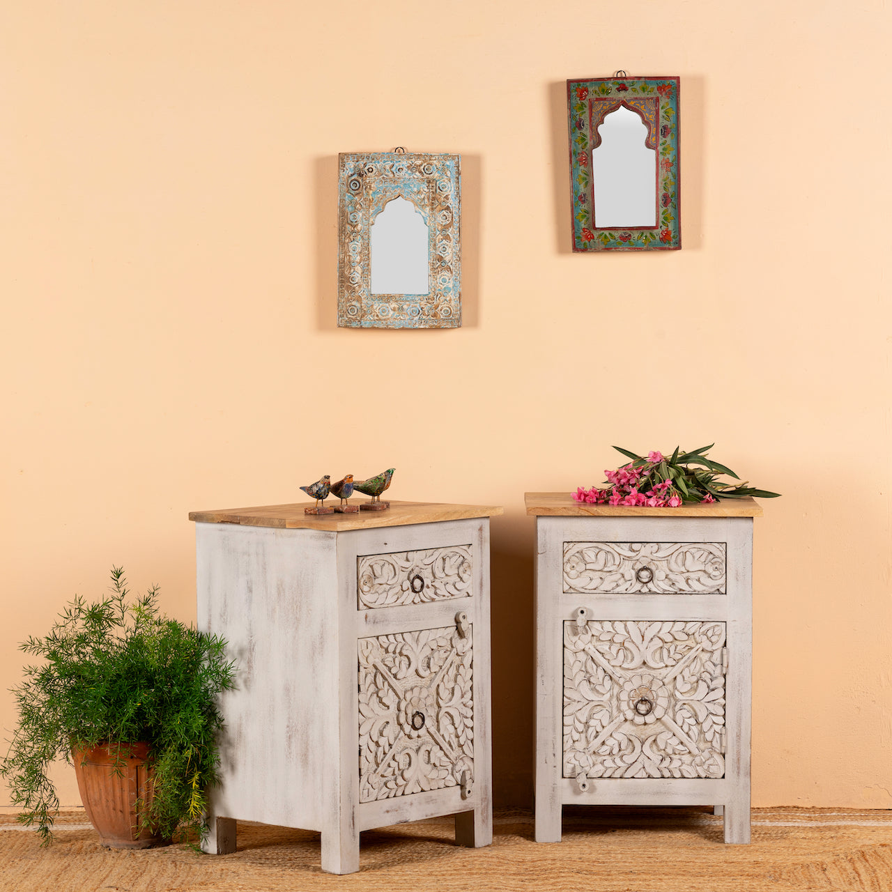 Side angle image of a pair of vintage night stands in mango wood with hand-carved geometric details and distressed finish; ideal for vintage home decor, 76 × 56 × 35 cm.