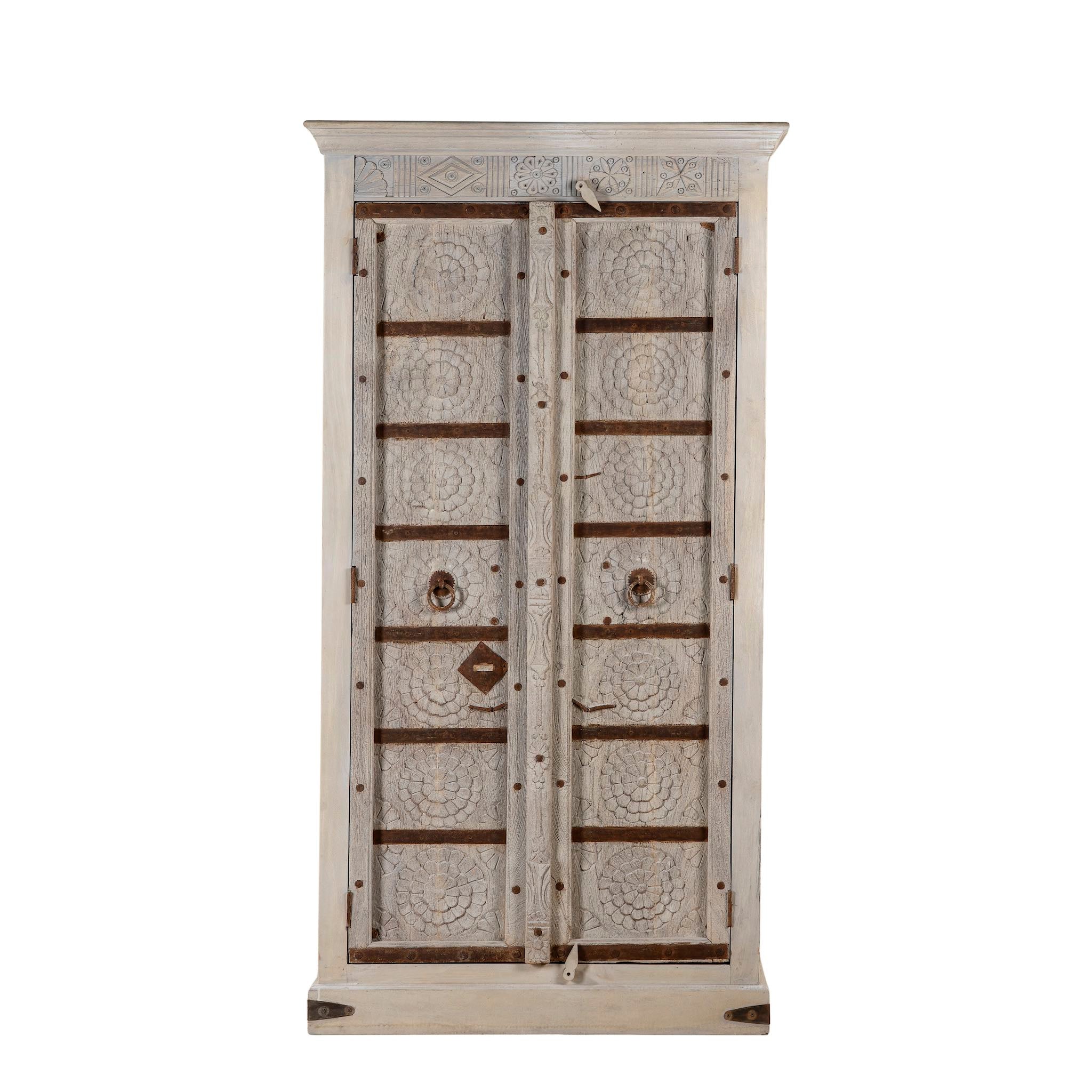 White background image of a old door cabinet with reclaimed teak doors, floral carvings, and iron accents; artisan teak wood wardrobe with mango wood frame, 100 × 44 × 206 cm.