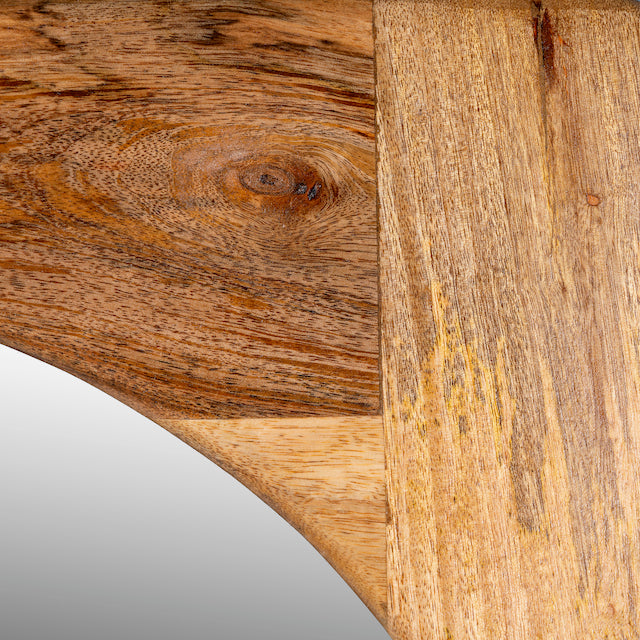Close up image of a mango wood mirror Bana with tall, arched frame and natural finish. A handcrafted piece of rustic wall art perfect for Mediterranean and minimalist interiors.