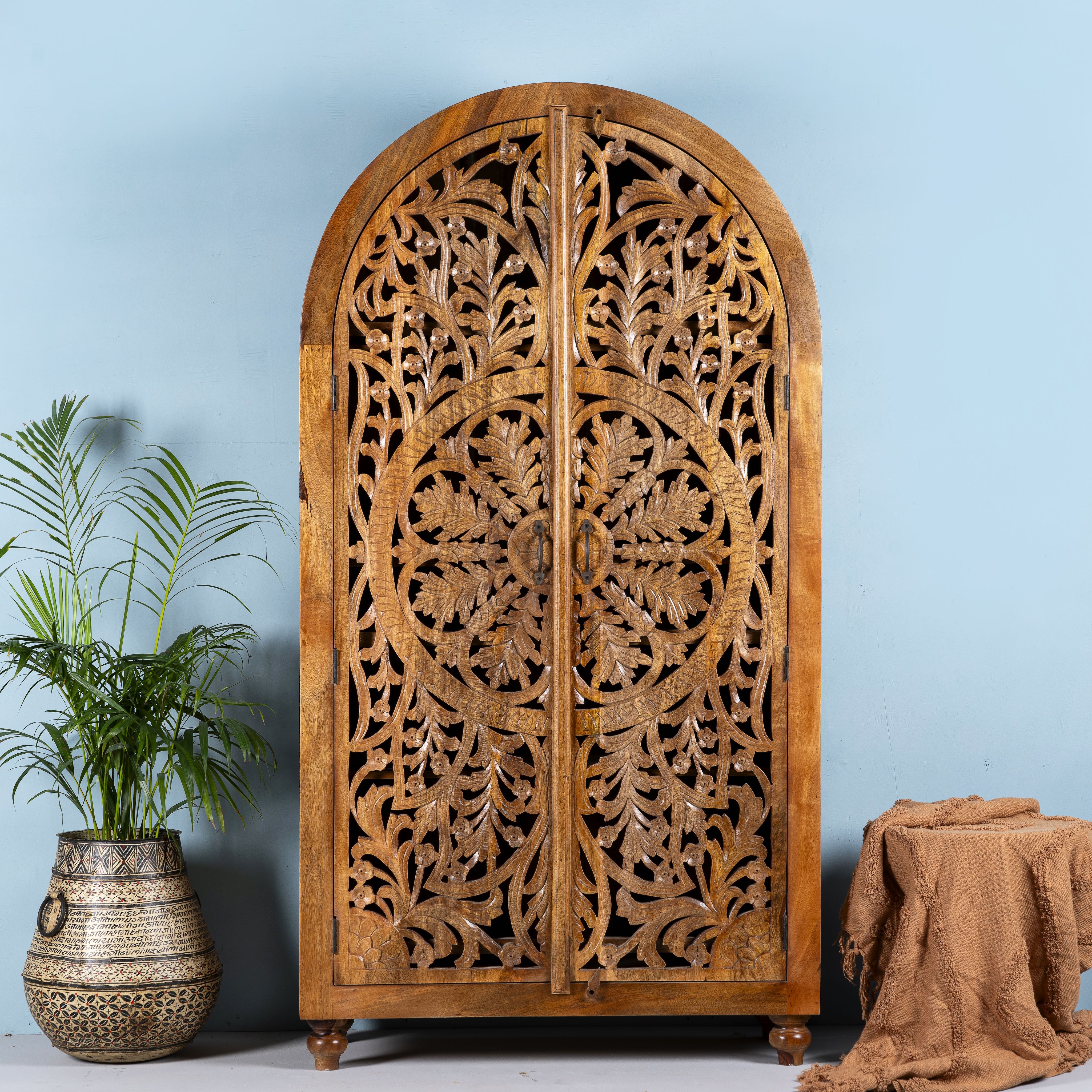 Unique wooden wardrobe made from solid mango wood with hand-carved floral design and rounded shape, 100 × 40 × 190 cm.