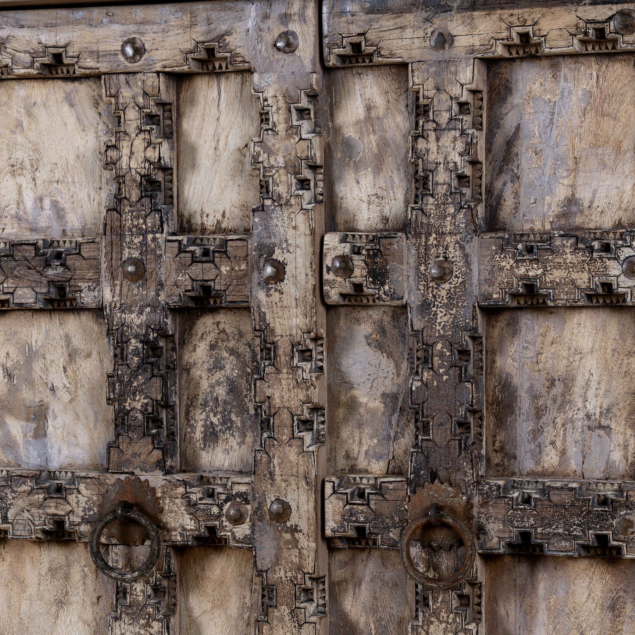 Foldable bar table made of reclaimed teak wood with inside storage and old door front.