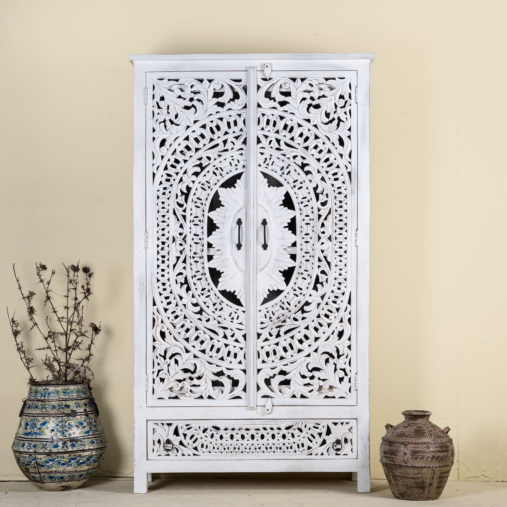 Hand-carved mango wood wardrobe with floral and geometric patterns and white-washed finish – carved wooden furniture for boho chic and Mediterranean-inspired interiors.