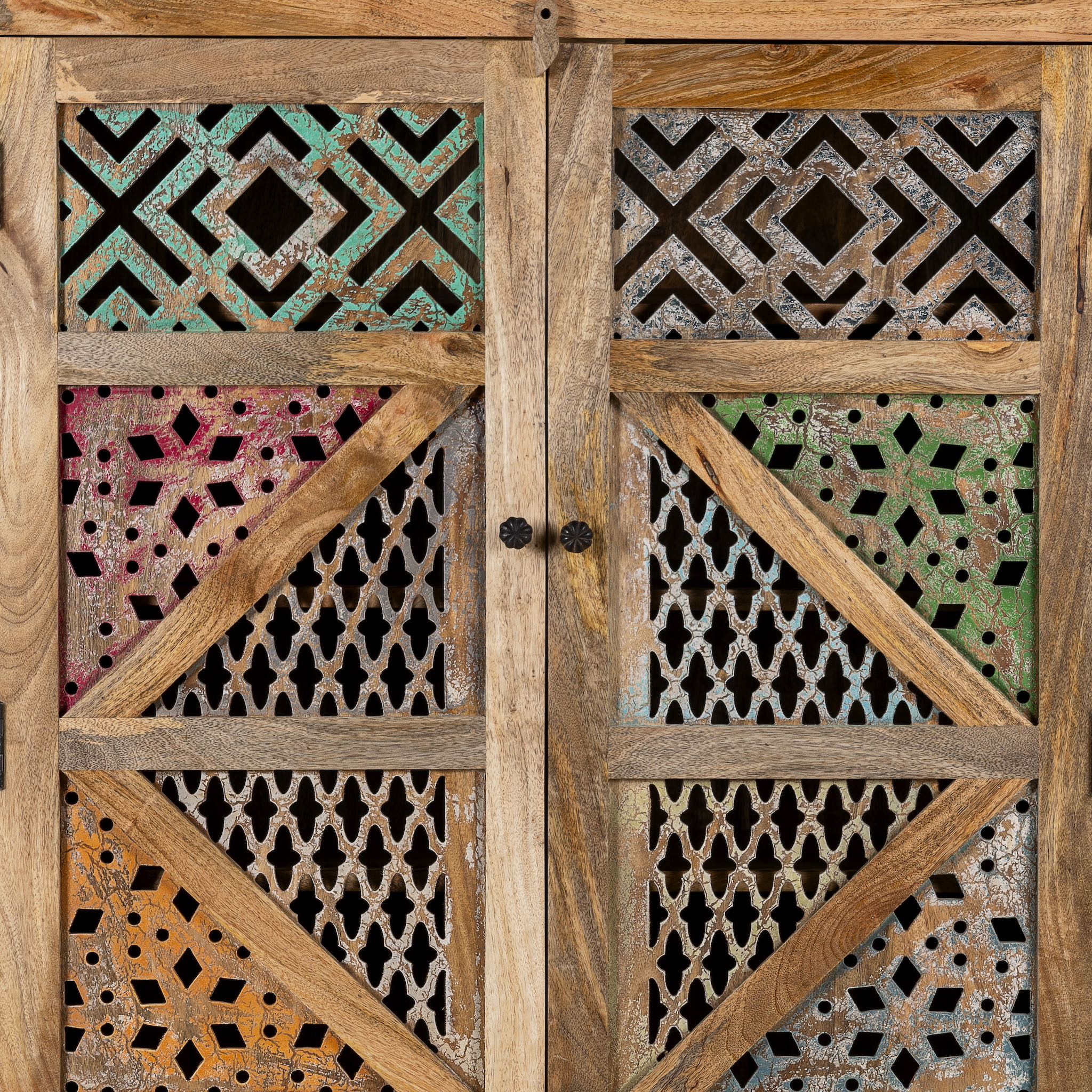 Close up image of a handmade mango wood cabinet with carved floral and geometric lattice doors, distressed colour accents; artisanal furniture perfect for boho style interiors, 100 × 45 × 130 cm.