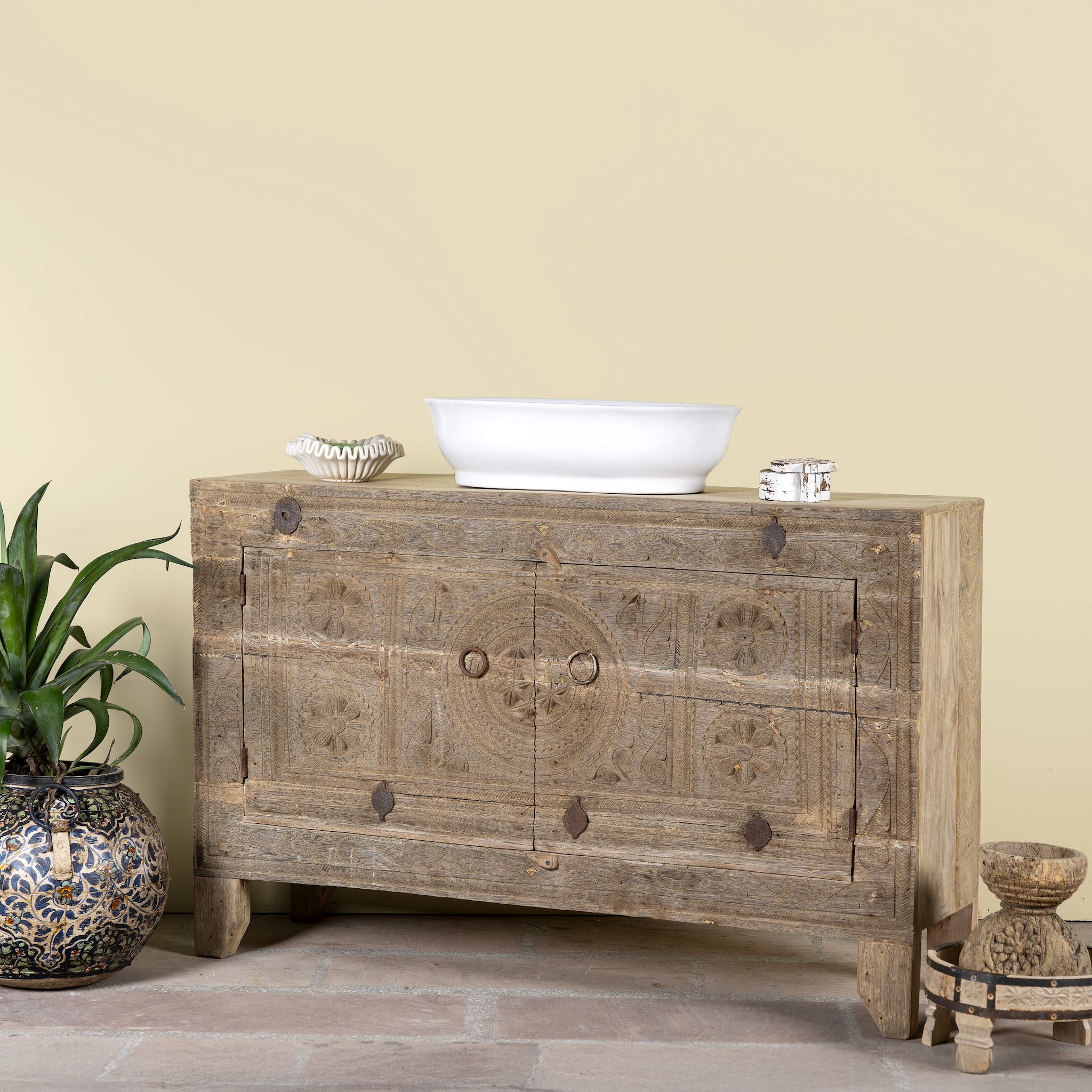 Side angle image of Etasha, a reclaimed wood sideboard made from antique teak doors with carved detailing; teak furniture, 130 × 38 × 83 cm.