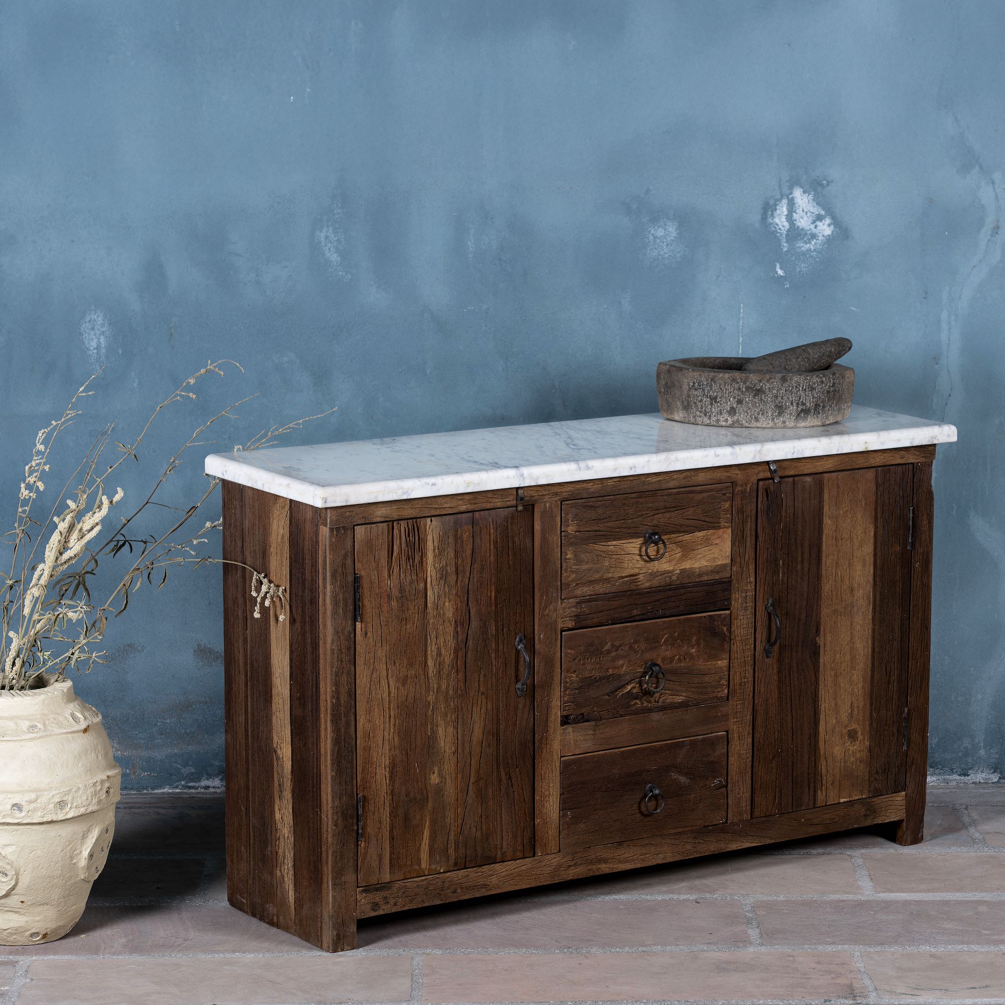 Side angle image of a wabi sabi furniture driftwood sideboard with white marble top, minimalist Japandi cabinet with drawers and sliding surface, 125 × 35 × 75 cm.