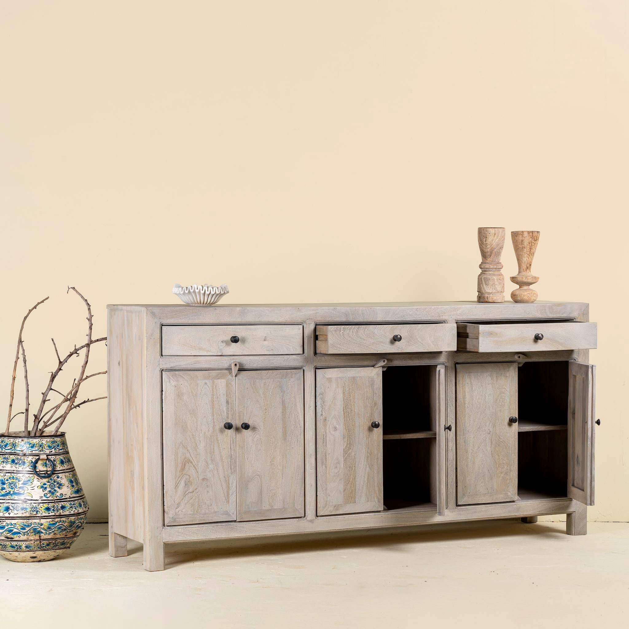 Open door image of a sandblasted mango wood sideboard with 3 drawers and 4 cabinet doors; Mediterranean-inspired mango wood furniture, 180 × 40 × 90 cm.