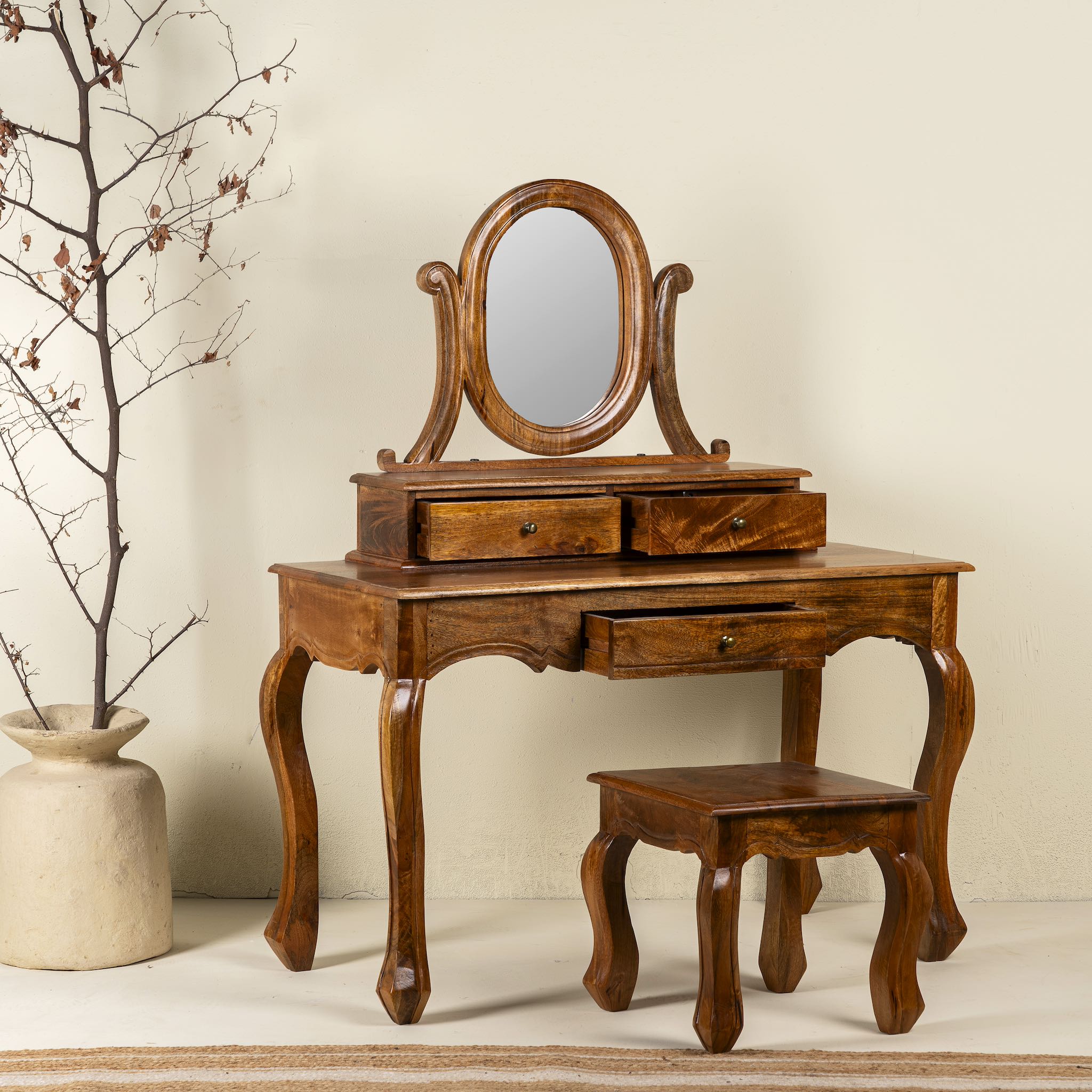 Side angle image of a wooden dressing table with mirror and matching chair, handcrafted mango wood table with drawers; vintage bedroom furniture, 110 × 50 × 145 cm.