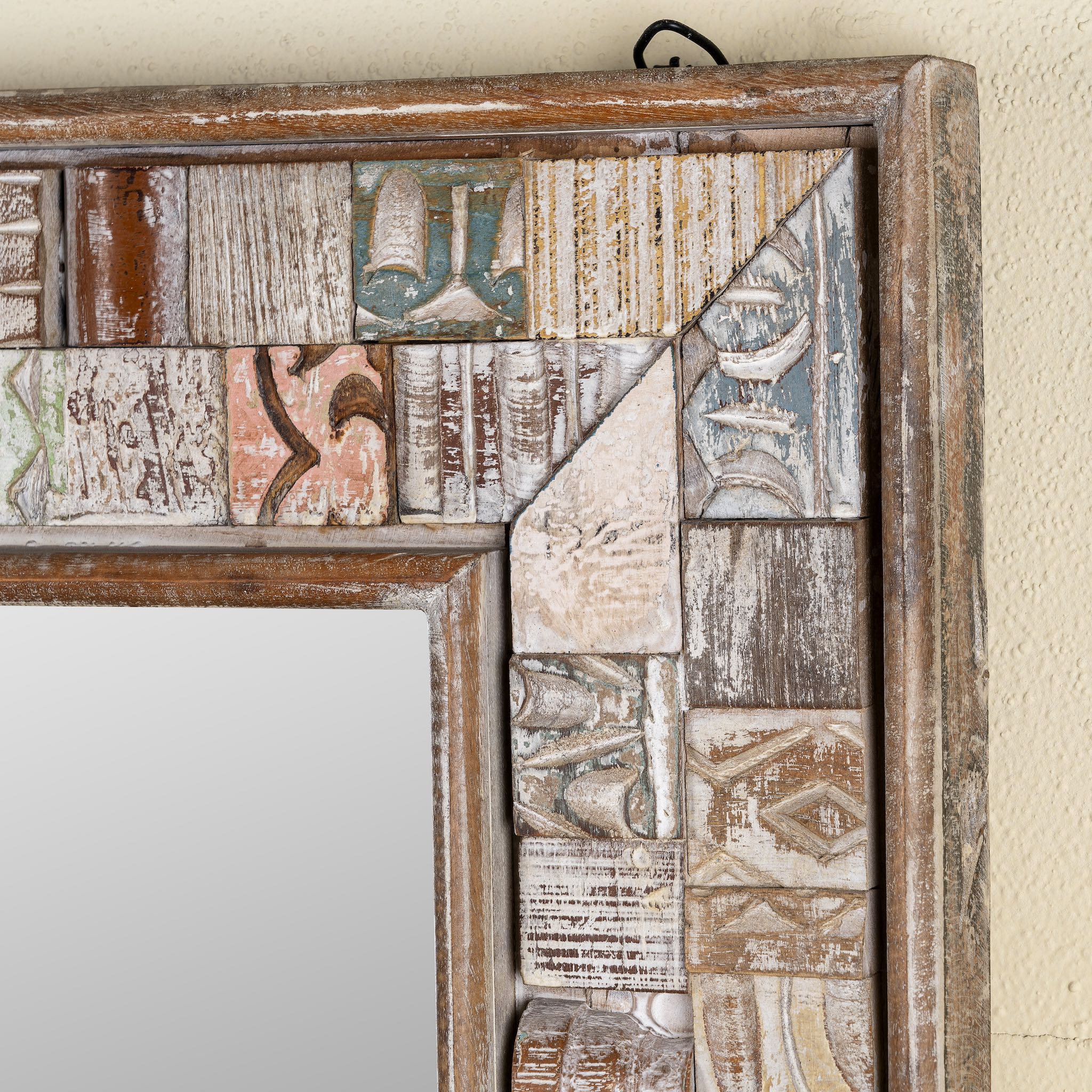 Close up image of a handmade mango wood mirror with patchwork reclaimed frame, distressed vintage finish; perfect for vintage home decor, 60 × 5 × 145 cm.