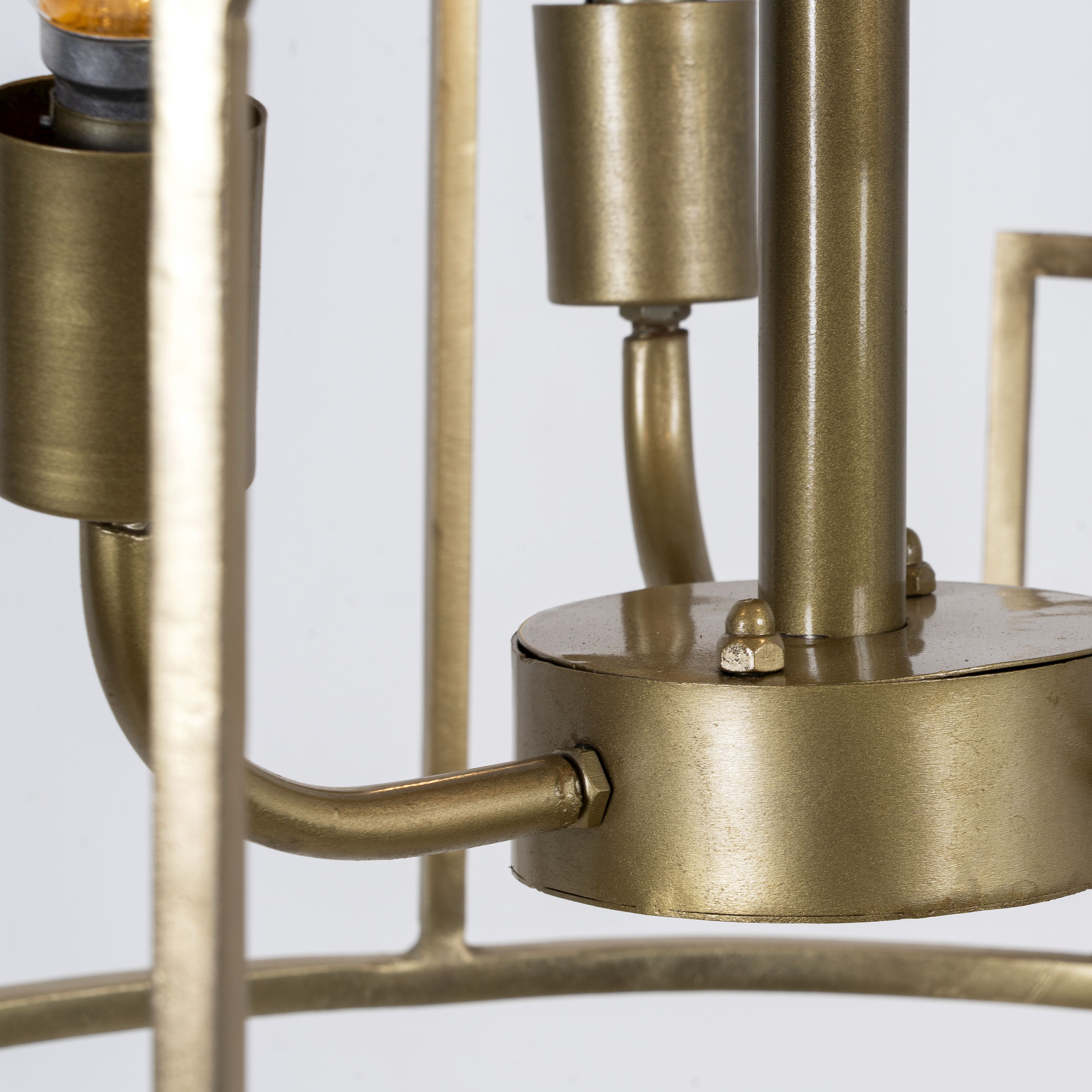 Close up image of a unique pendant light with round shiny brass-plated frame and magnifying glass inserts – vintage lighting with three-light design for dining rooms, kitchens, or elegant interiors.