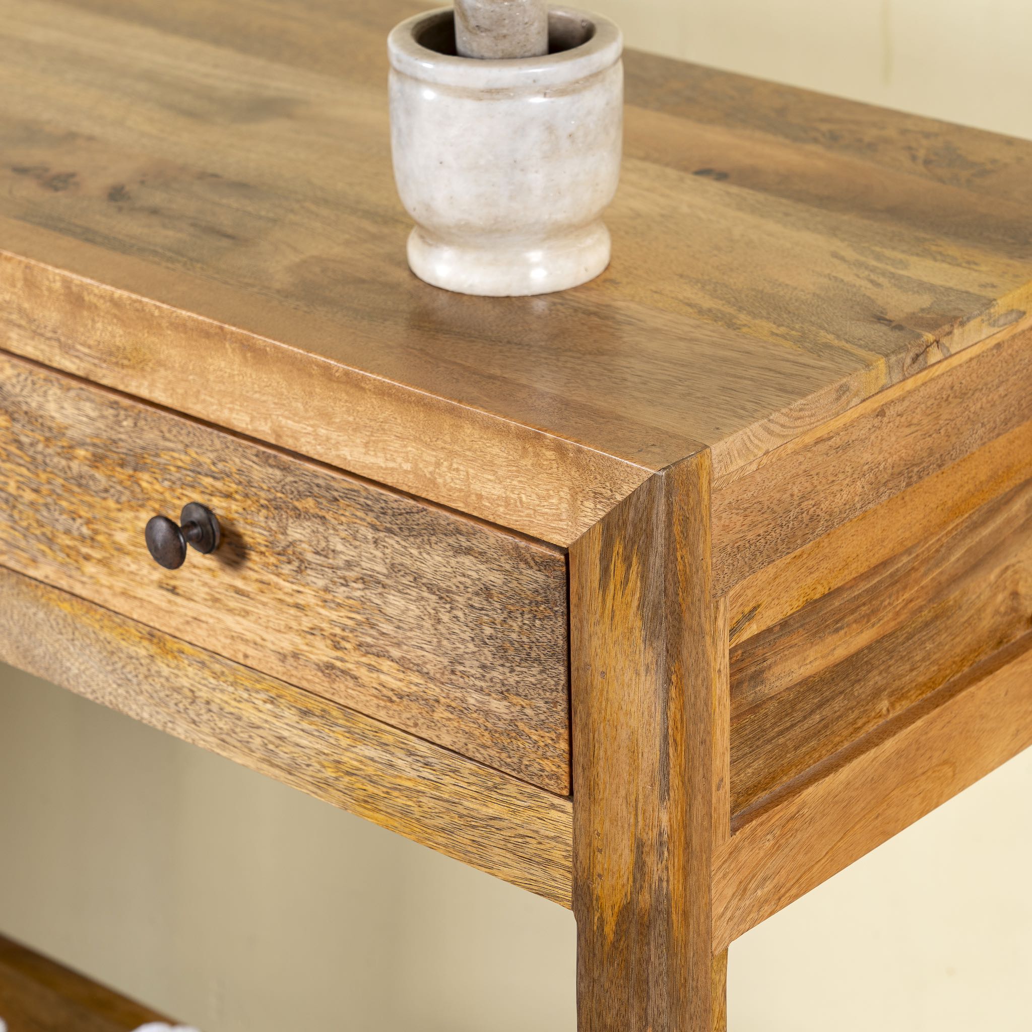 Close up image of a Ibiza style Mango wood console table with two drawers and bottom shelf, warm natural finish, 100 × 40 × 90 cm.