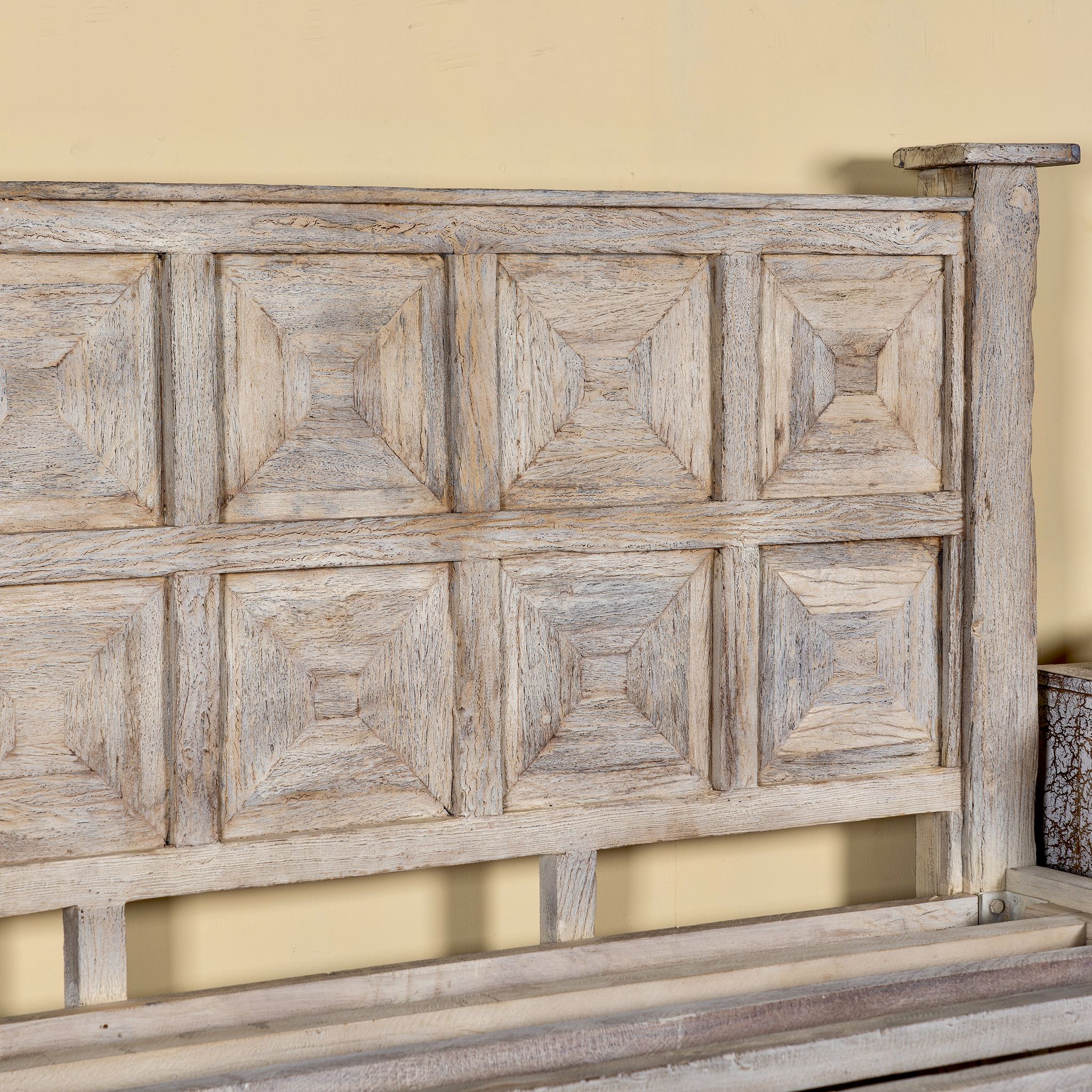 Close up image of a wooden bed frame with panelled headboard and footboard, made of reclaimed wood in sandblasted Ibiza style, boho beds and bedroom furniture, 180 × 200 × 140 cm.