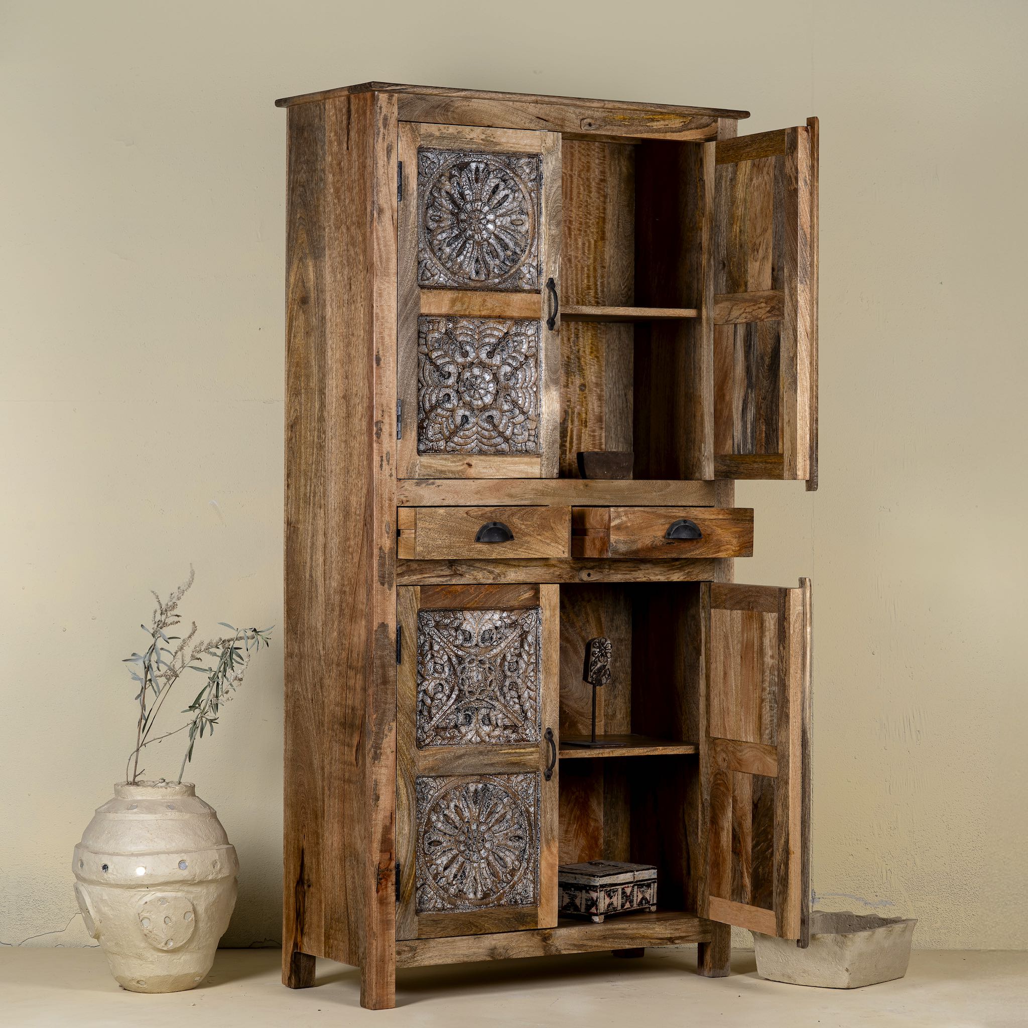 Open door picture of a hand-carved mango wood cabinet with floral motifs and silver finish – bedroom furniture with rustic charm and artisanal detail.