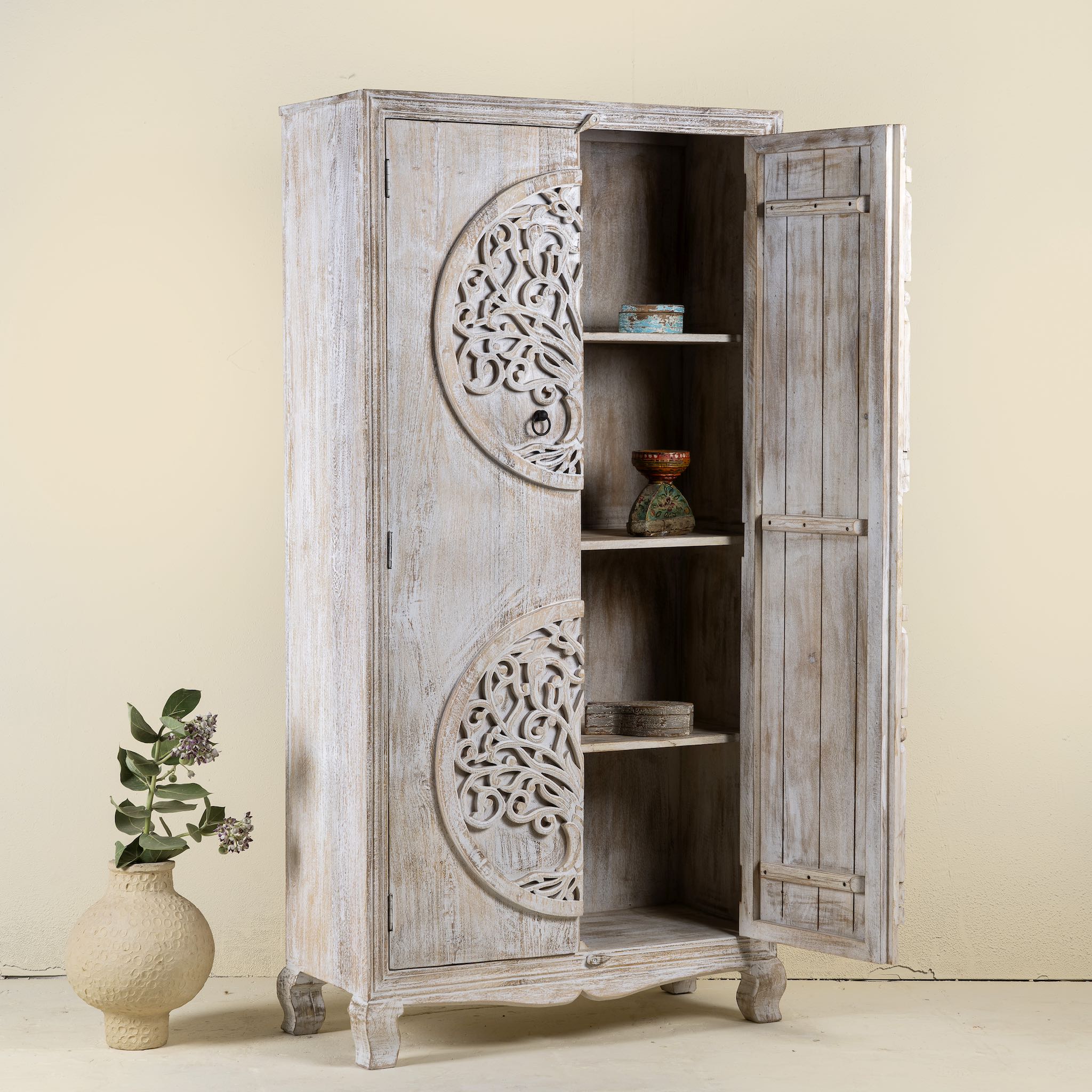 Open door image of a hand-carved mango wood wardrobe with Tree of Life design, distressed finish, ideal for bohemian interiors, 90 × 40 × 180 cm.