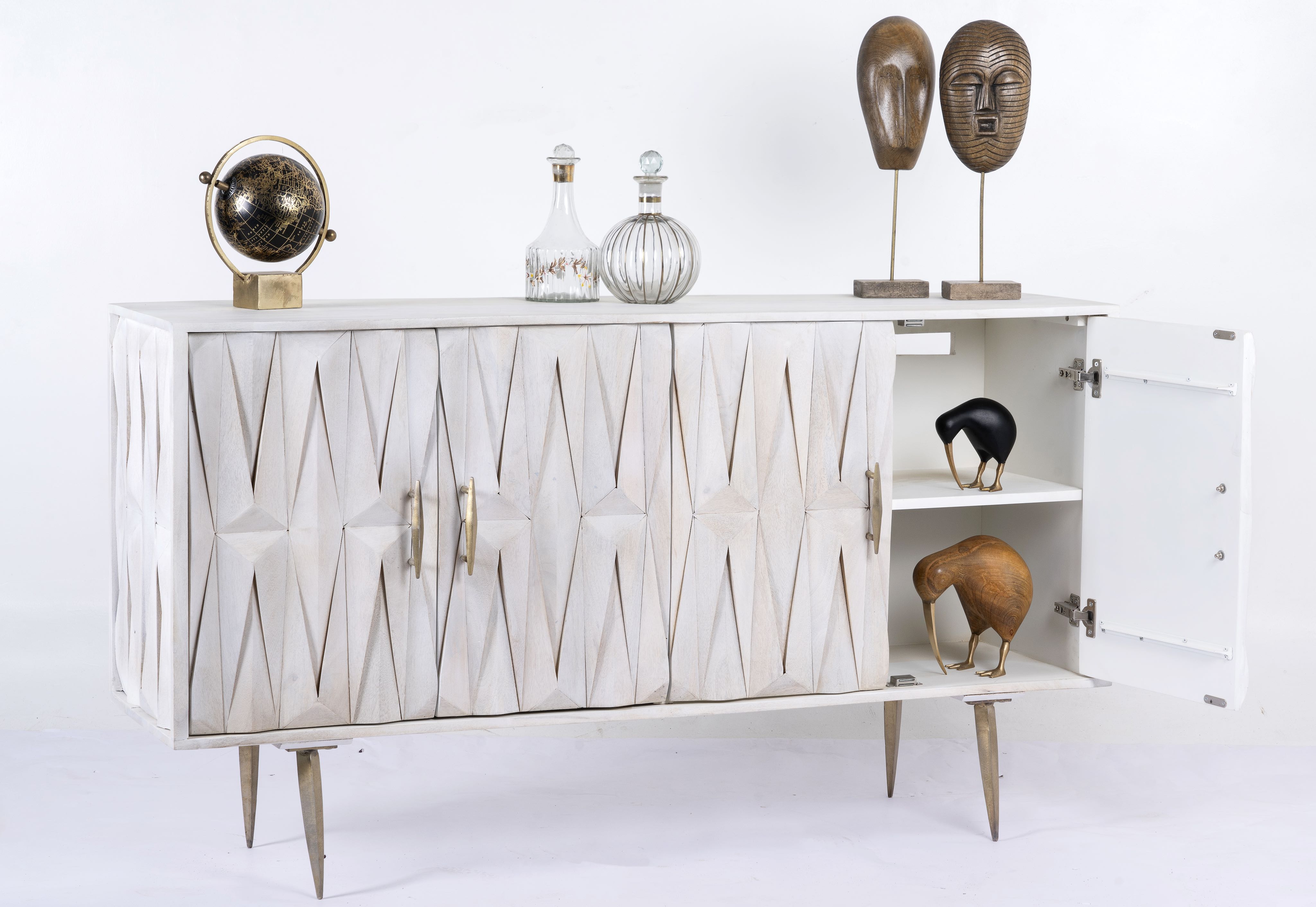 Side angle image with open door of a whitewashed mango wood sideboard with raised criss-cross design, four doors, and silver metal legs—elegant living room furniture with modern rustic appeal.