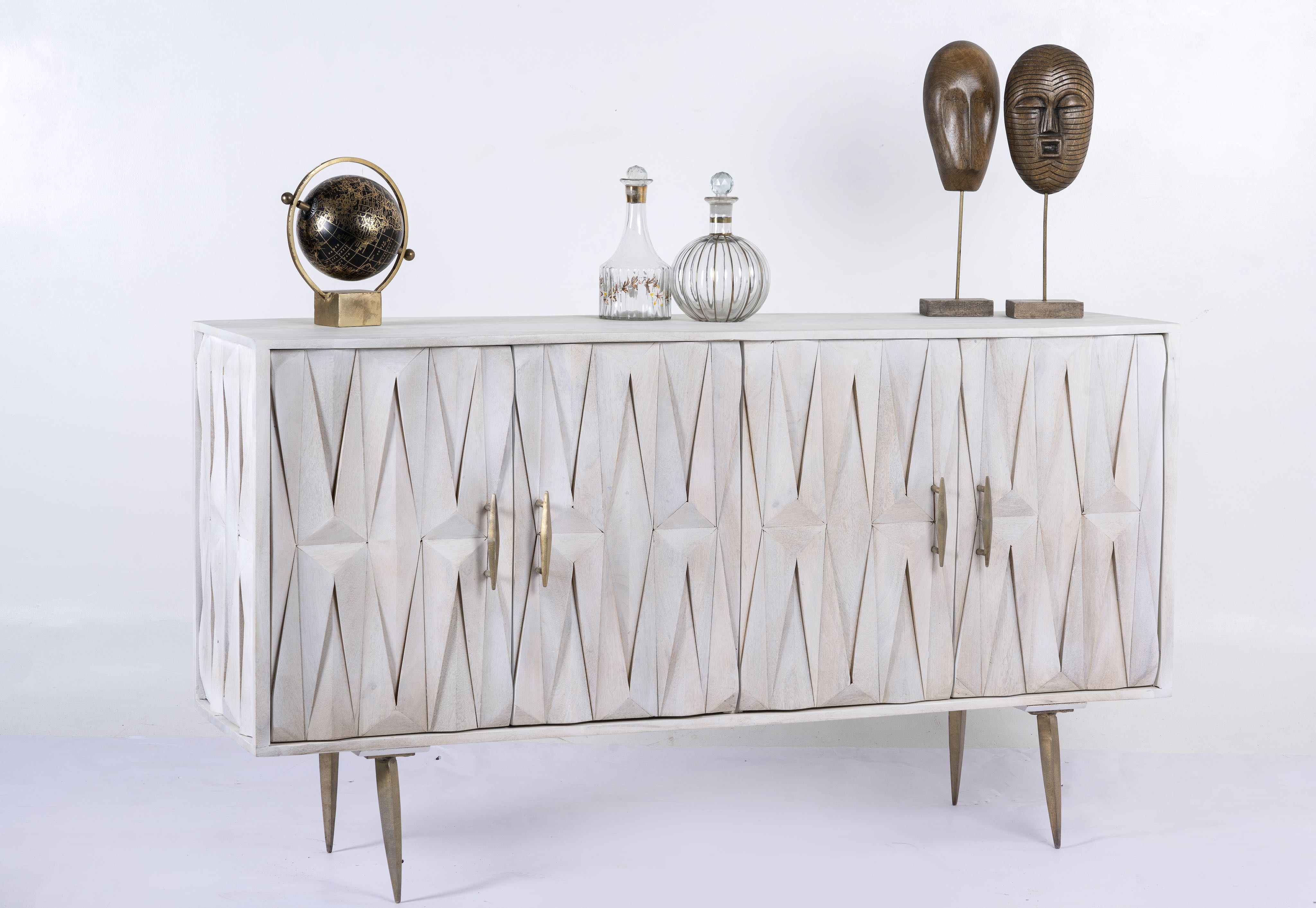 Side angle image of a whitewashed mango wood sideboard with raised criss-cross design, four doors, and silver metal legs—elegant living room furniture with modern rustic appeal.