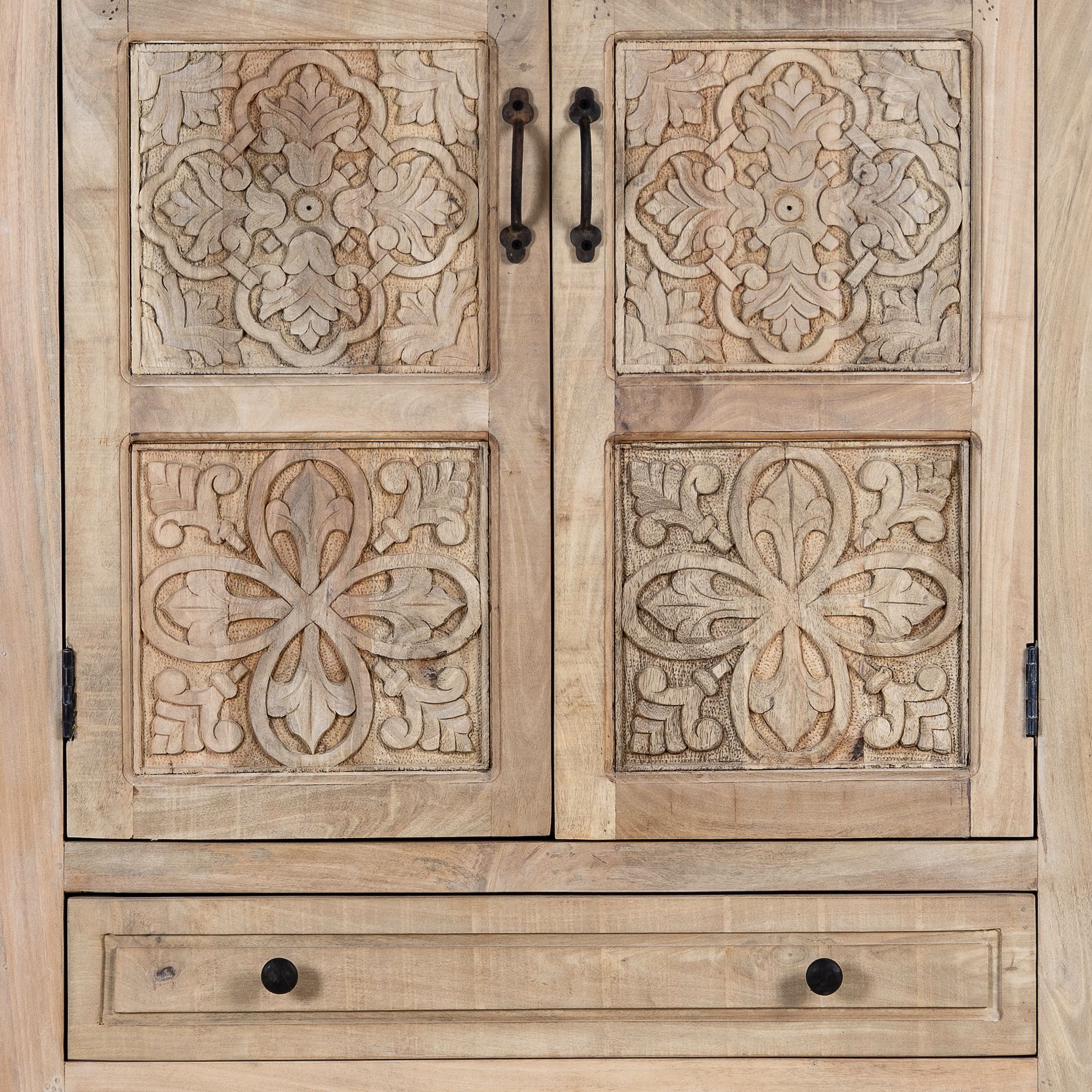 Close up picture of a hand-carved mango wood cabinet with floral and geometric detailing – carved wooden furniture and elegant bedroom storage by Om Home & Garden.