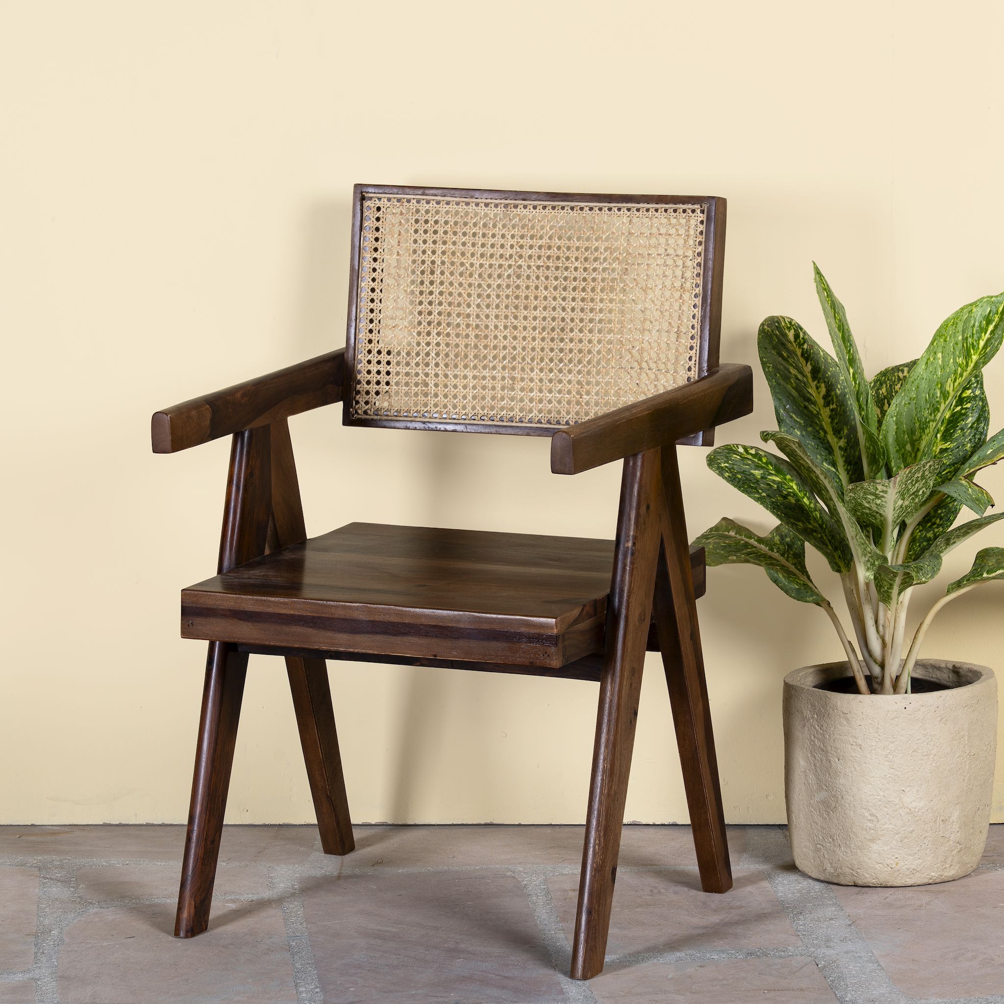 Acacia wood chair with rattan backrest and armrests; elegant wooden armchair for dining or living rooms, 55 × 55 × 85 cm.