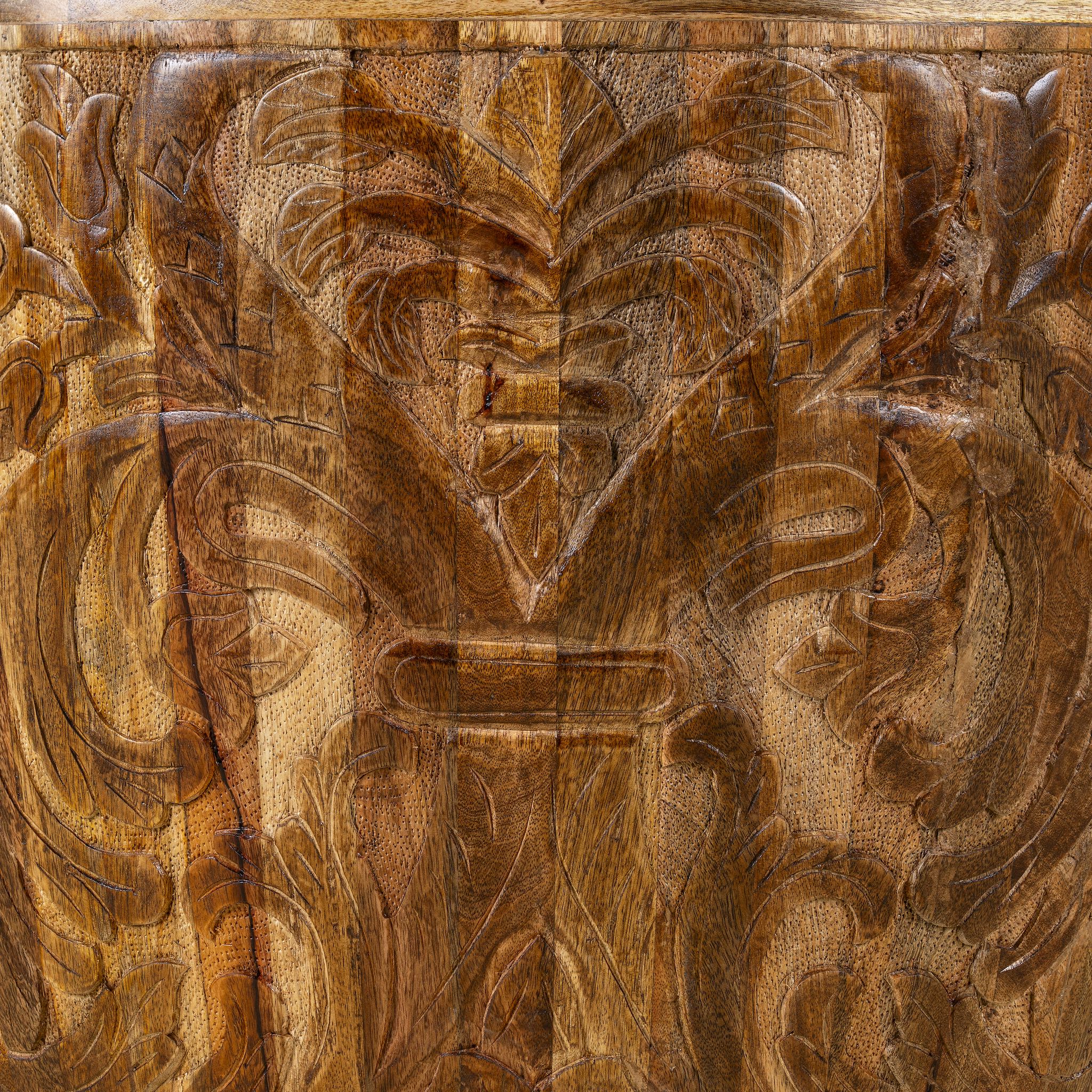 Close up image of a round mango wood coffee table with hand-carved detailing and natural finish; rustic carved coffee table, 90 cm diameter, 52 cm height.