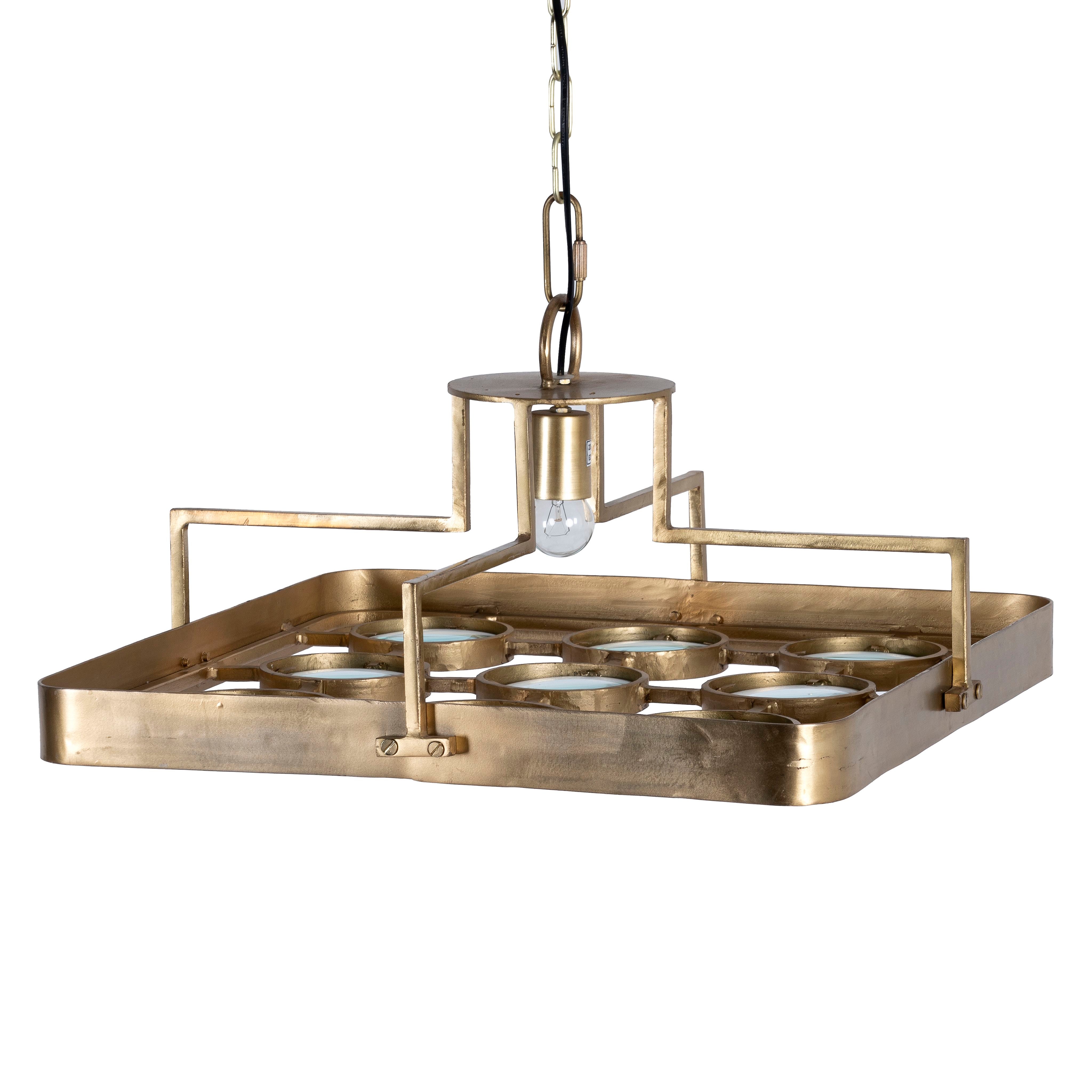 White background image of a unique pendant light with square brass-plated iron frame and magnifying blue and white glass inserts – a vintage lighting piece for kitchens, dining rooms, or living areas.