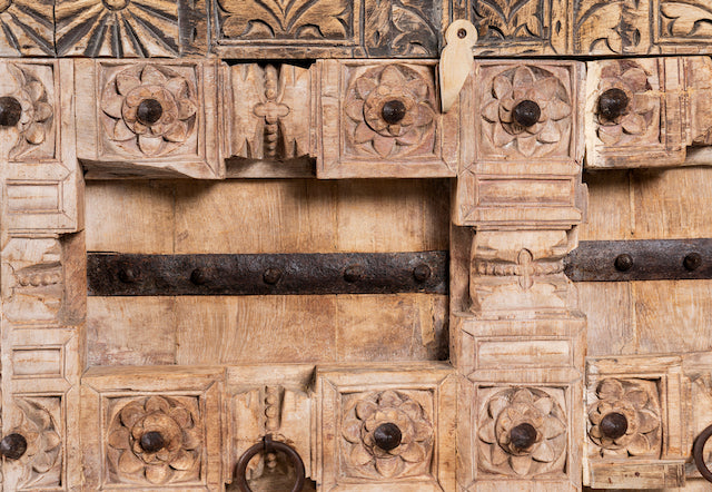Close up image of a whitewashed reclaimed teak sideboard in Ibiza style, featuring sandblasted old wood surfaces and rustic design; 112 × 90 × 50 cm.