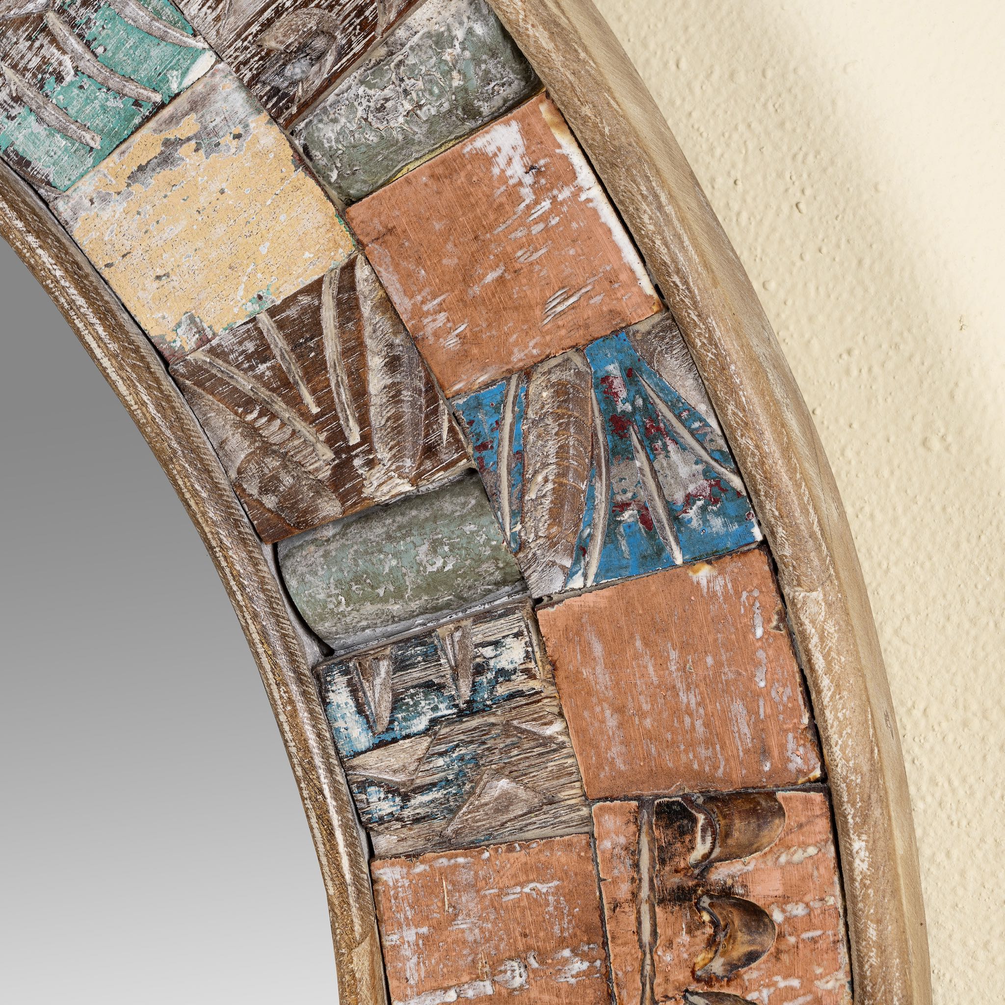 Close up image of a handcrafted round mango wood mirror with patchwork reclaimed frame and distressed finish; ideal for vintage home decor, 80 × 4 cm.