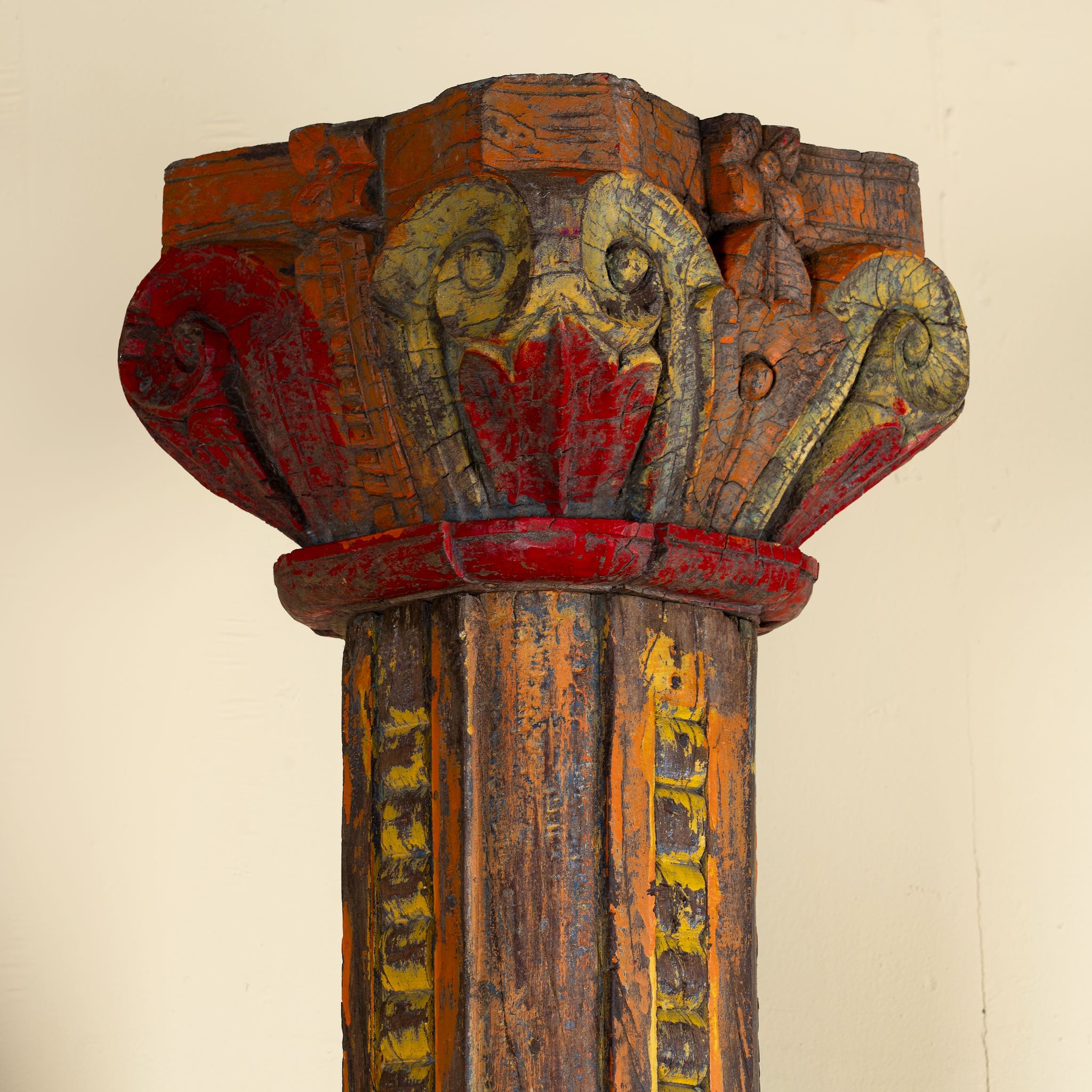 Close up image of an antique pair of carved wooden house pillars with original stone bases, weathered multicolour finish, 210 cm high, vintage home decor and boho chic living room accents.