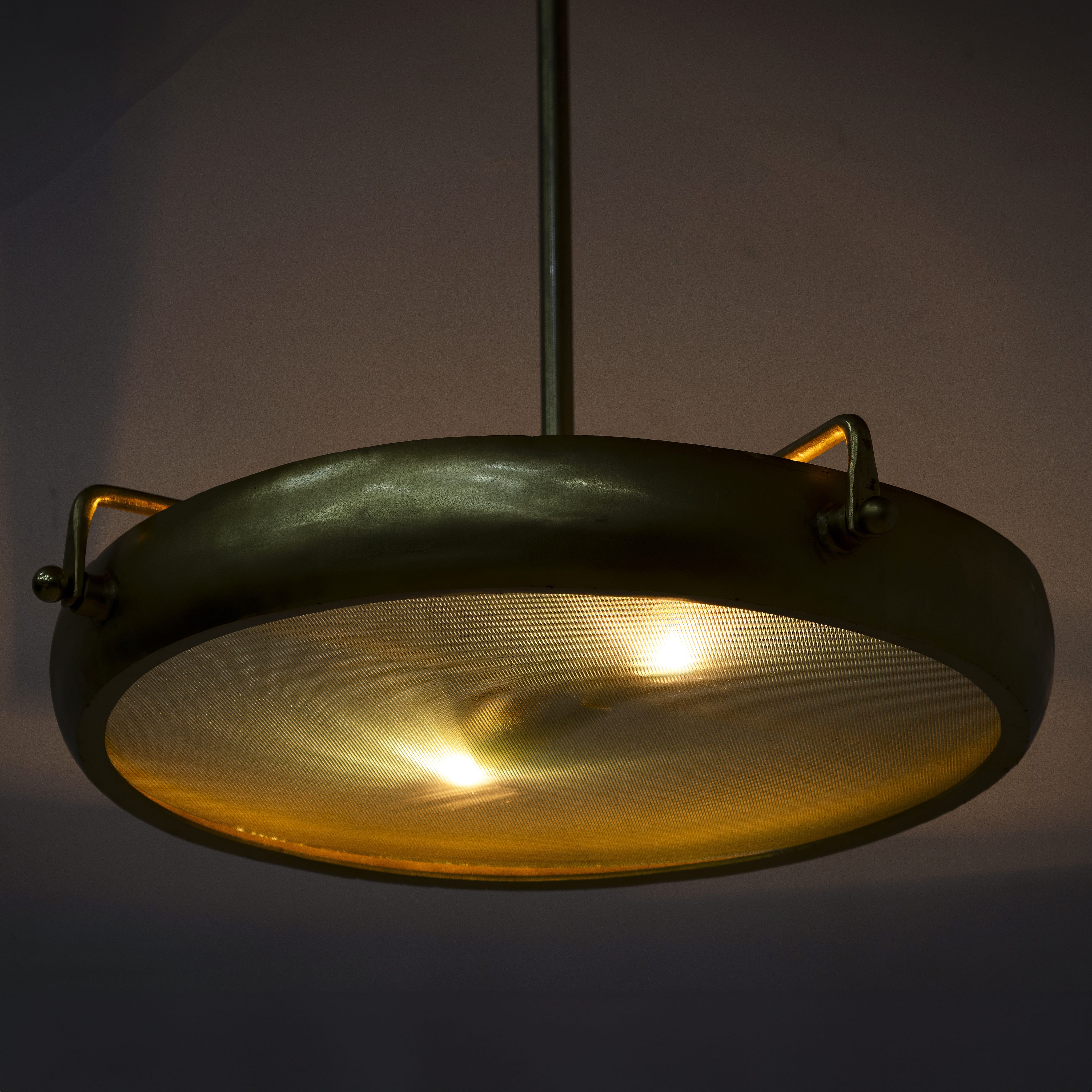 Image showing a extra-large round pendant lamp with clear glass and brass-plated iron frame – retro lighting and artsy lamp ideal for kitchens, dining rooms, or open living spaces.
