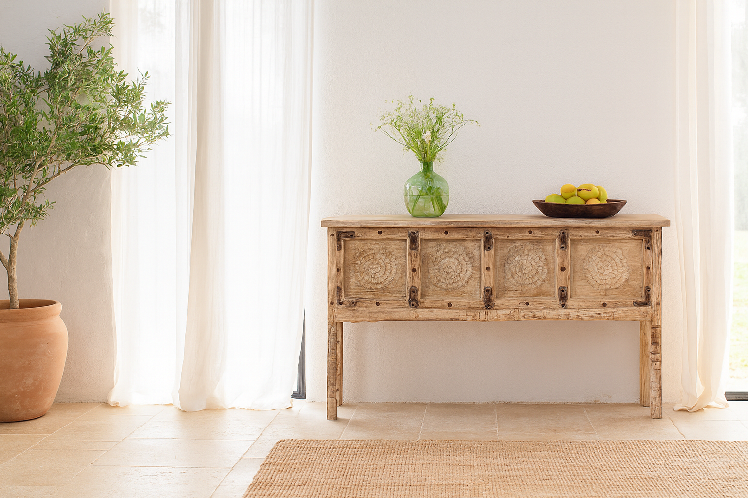 Lifestyle imagination of a reclaimed teak wood console table with hand-carved floral fronts and iron accents; sustainable furniture, 153 × 80 × 40 cm.