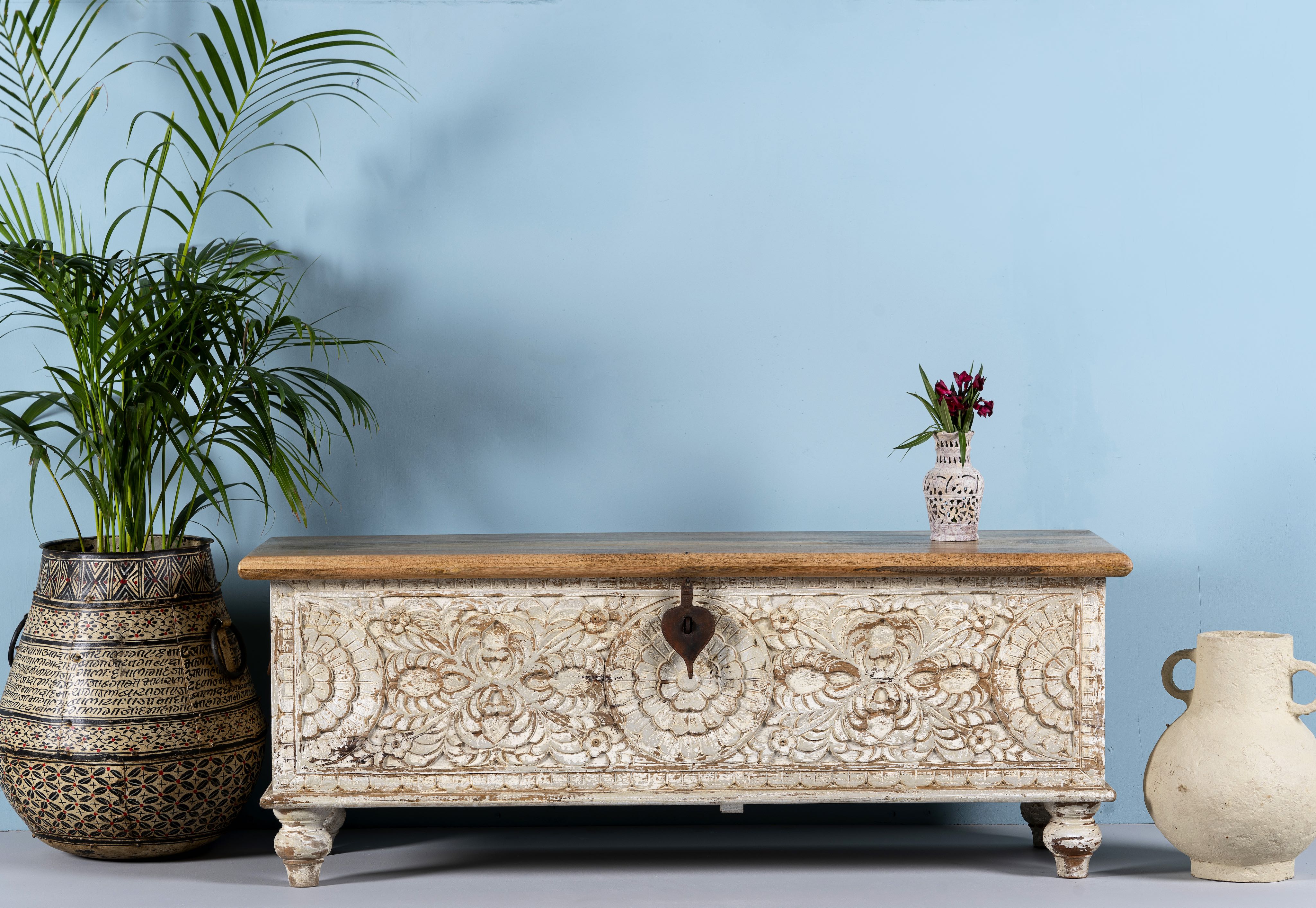 Hand-carved mango wood chest box with floral motifs, whitewashed finish, and iron handles – vintage home accessory for rustic and elegant interiors.