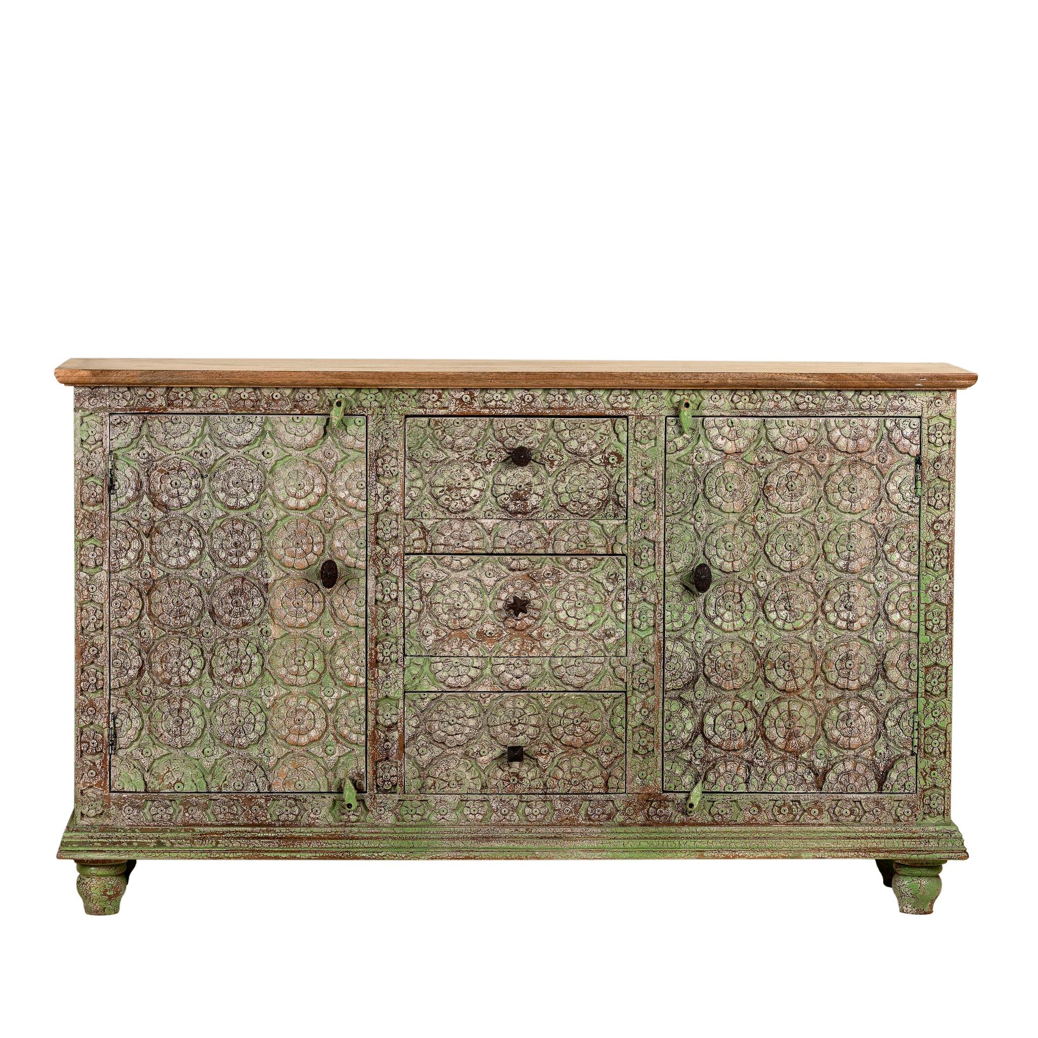White background image of a carved wooden furniture sideboard with floral hand-carving and distressed finish, vintage style cabinet made from mango wood, 150 × 40 × 90 cm.