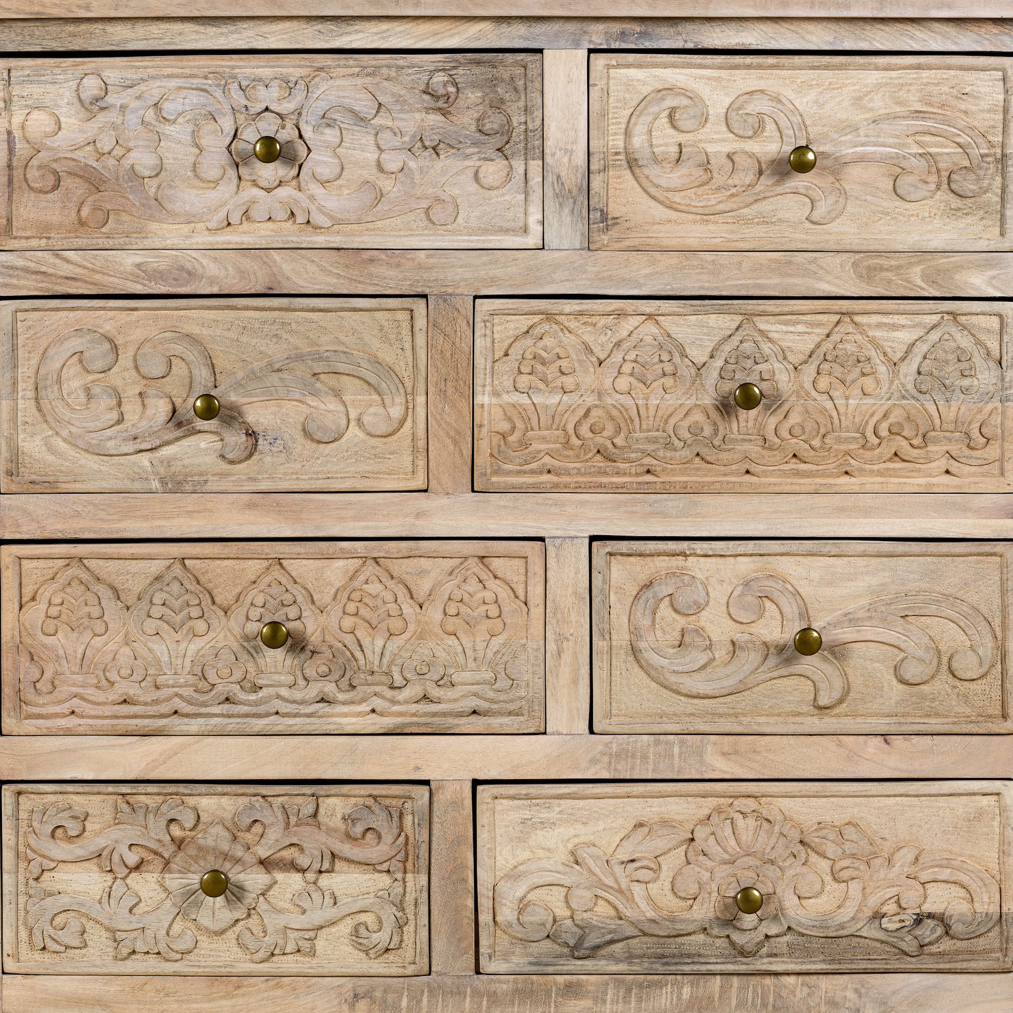 Close up image of a carved mango wood cabinet with drawers and one door, made from reclaimed teak, 100 × 40 × 100 cm.