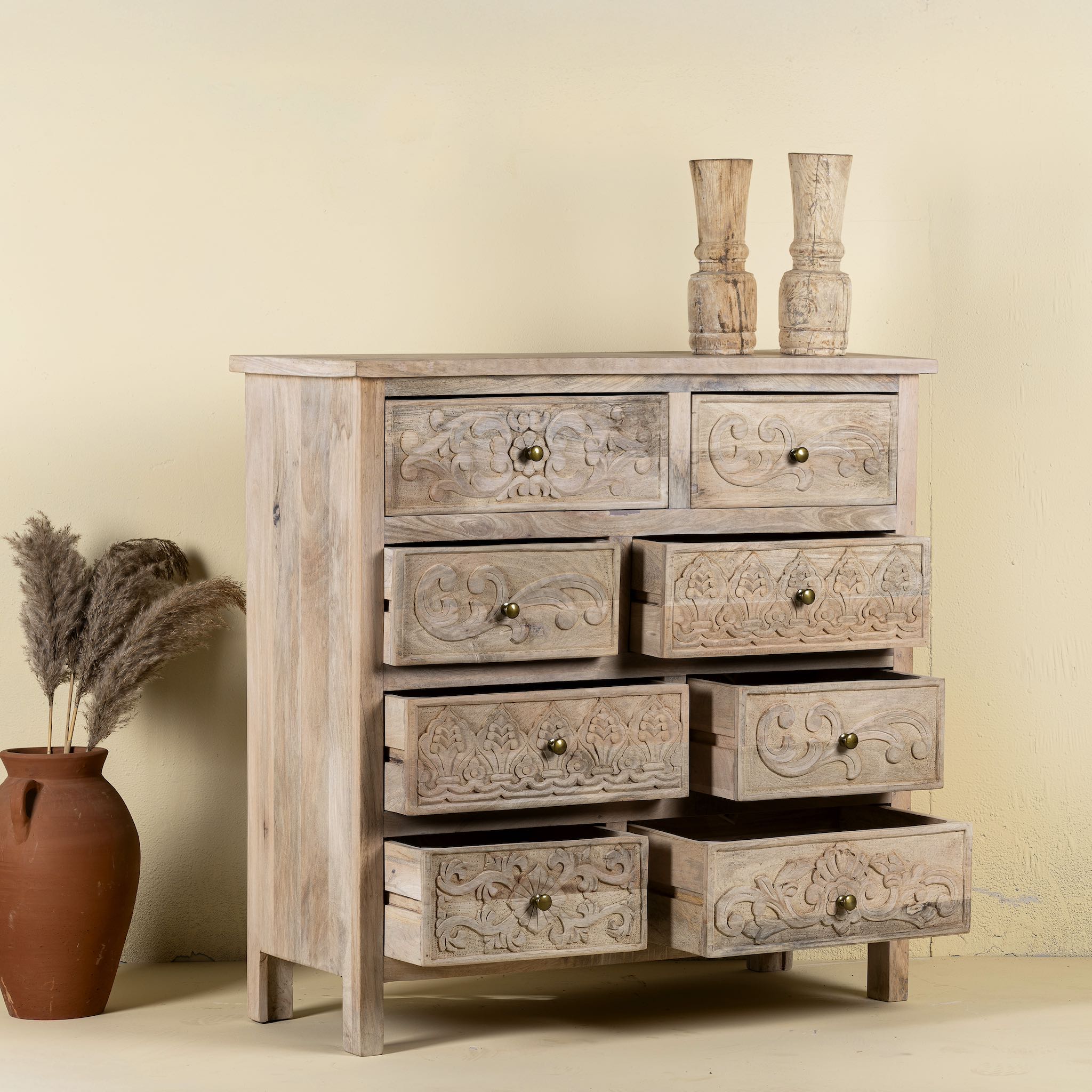 Open drawers image of a carved mango wood cabinet with drawers and one door, made from reclaimed teak, 100 × 40 × 100 cm.