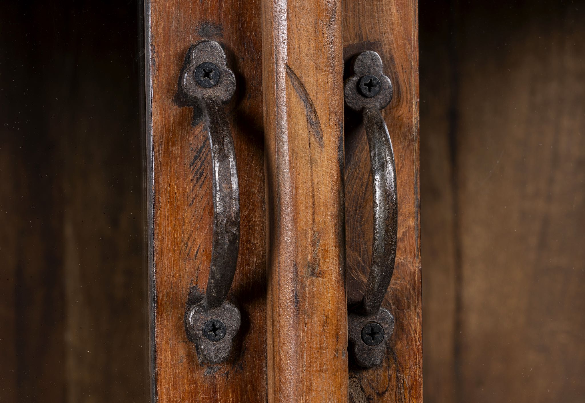 Close up image of a compact reclaimed teak wood display cabinet with two glass doors and shelving – sustainable teak wood furniture combining functional design and unique character.