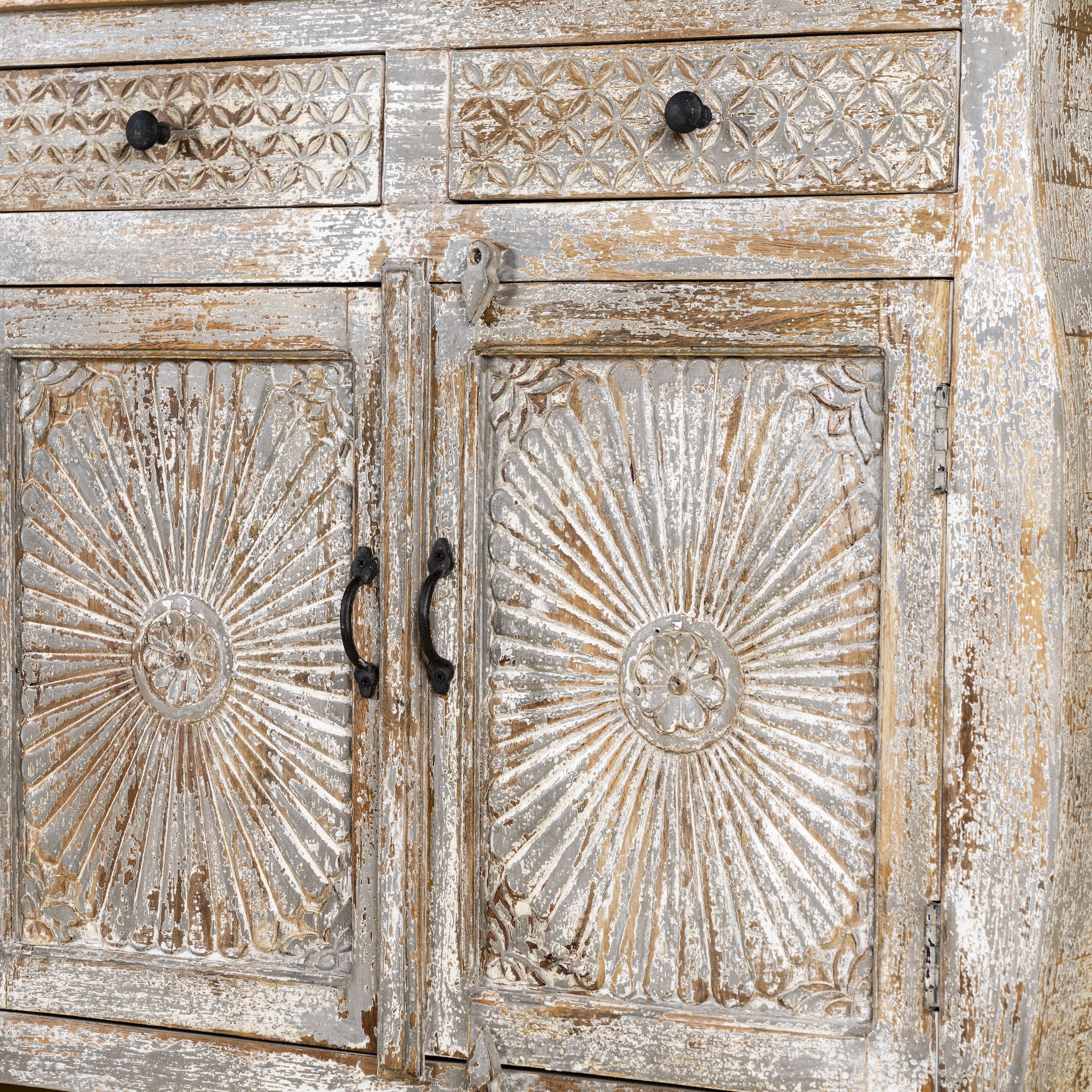 Close up image of a living room furniture sideboard made from hand-carved mango wood, vintage style furniture with sunburst patterns and distressed finish, 180 × 40 × 90 cm.