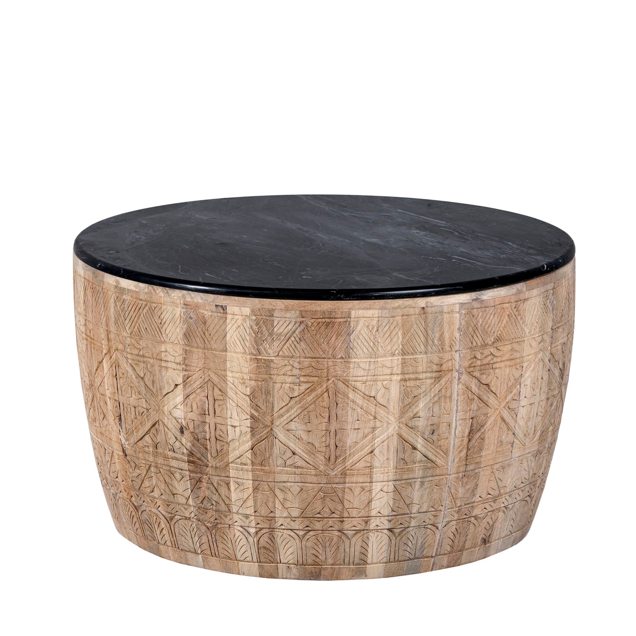 White background picture of a elegant round hand carved coffee table made of sustainable Mango wood with floral design and black marble top.
