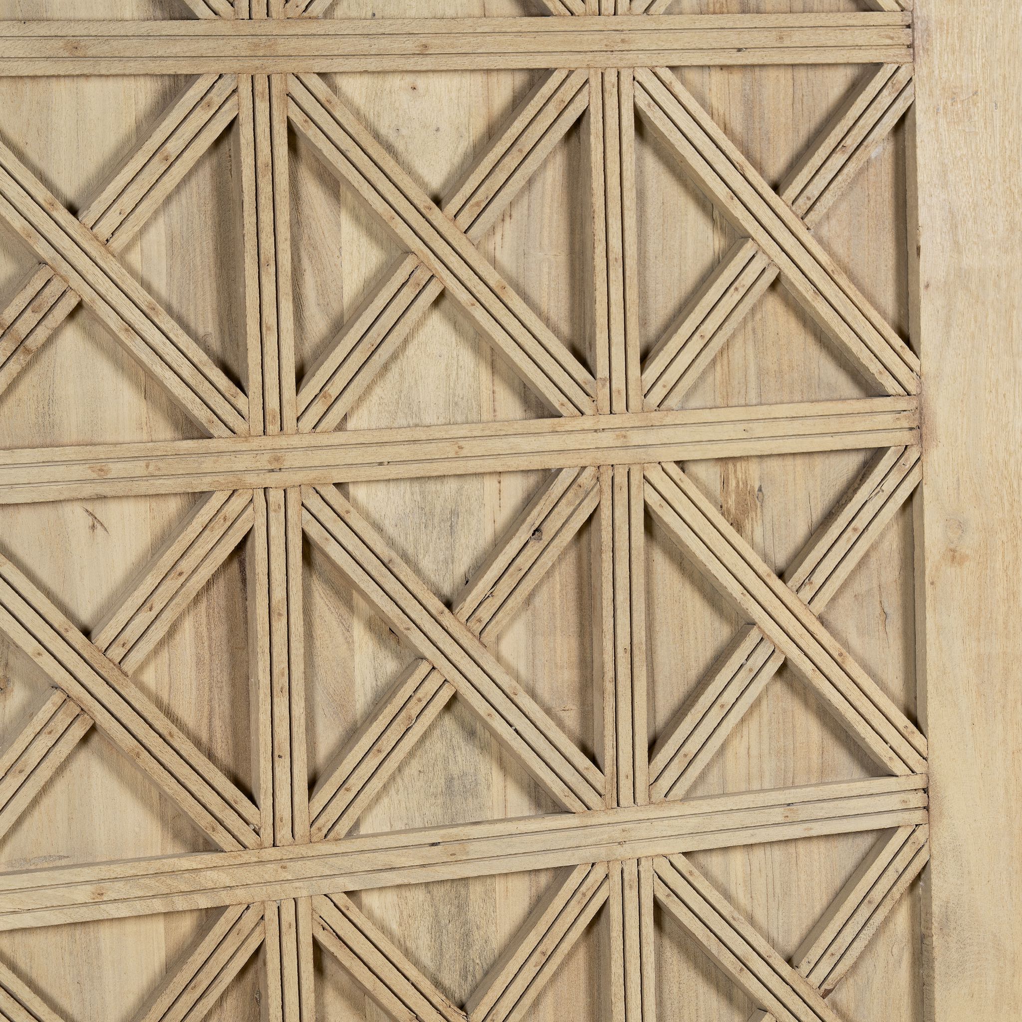 Close-up of a wooden panel with a geometric lattice pattern