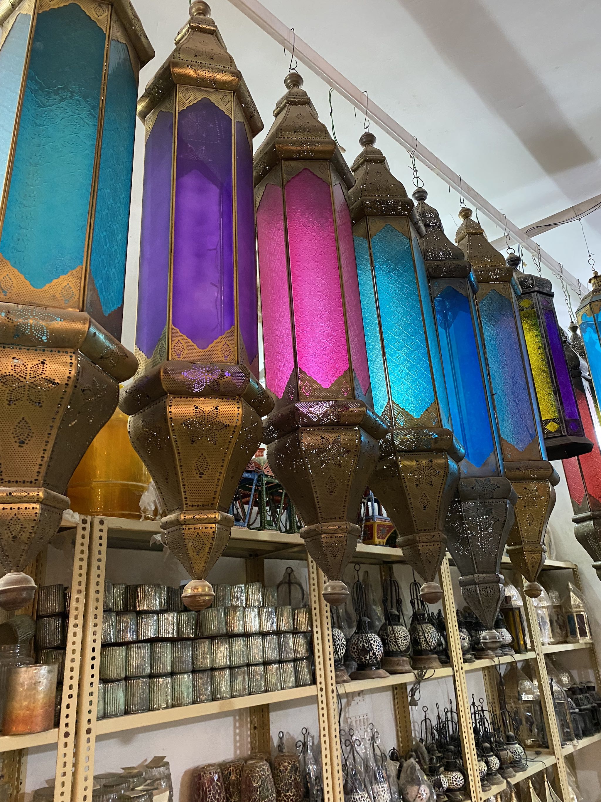 Tall oriental pendant lamp Ovin made from punched metal and coloured Belgium glass – 100 cm hanging lantern in red, yellow, white, and blue for vibrant atmospheric lighting.