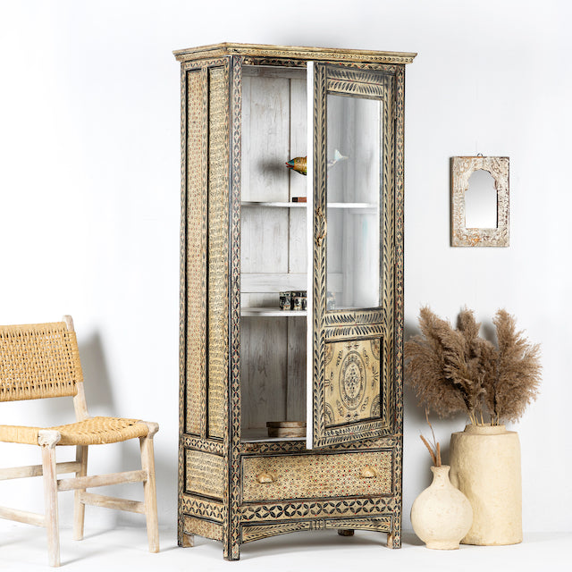 Side angle image with open door of a hand-painted Indian display cabinet with engraved Sanskrit motifs, drawer and compartments – unique Indian furniture made from recycled wood with artisanal detail.